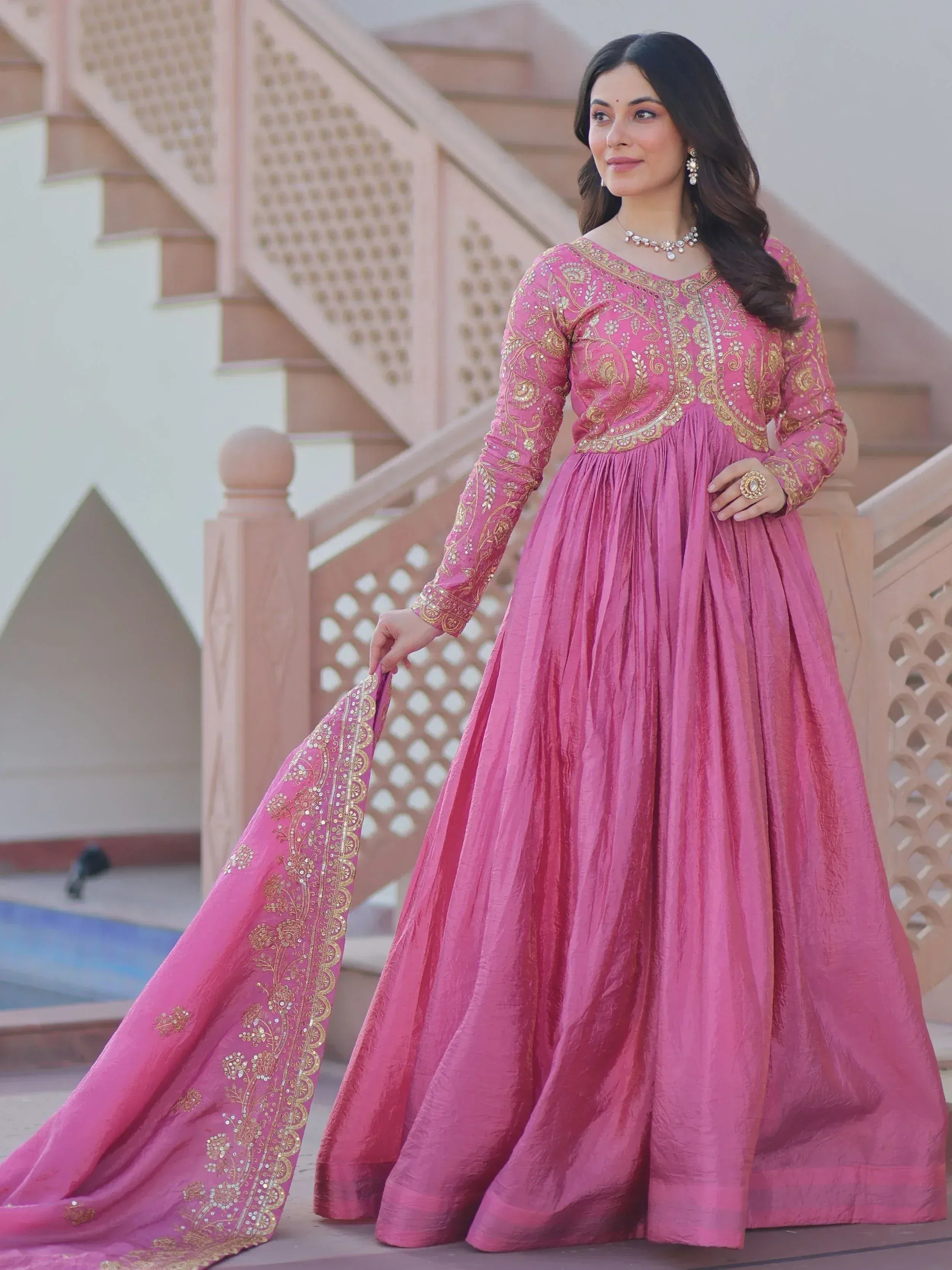 Pink ethnic gown with gold embroidery, perfect for Indian weddings and festive occasions