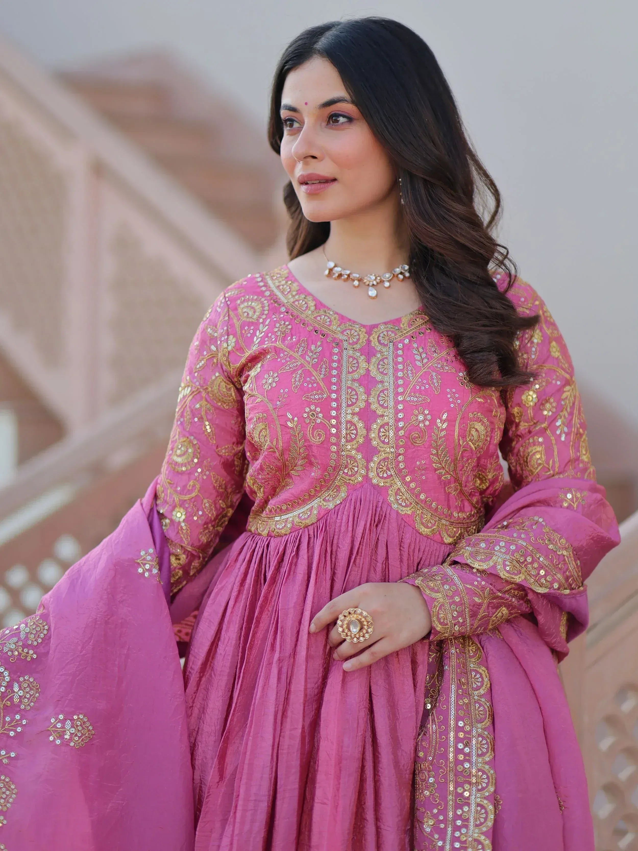 Pink embroidered ethnic gown with gold detailing, perfect for Indian festive occasions