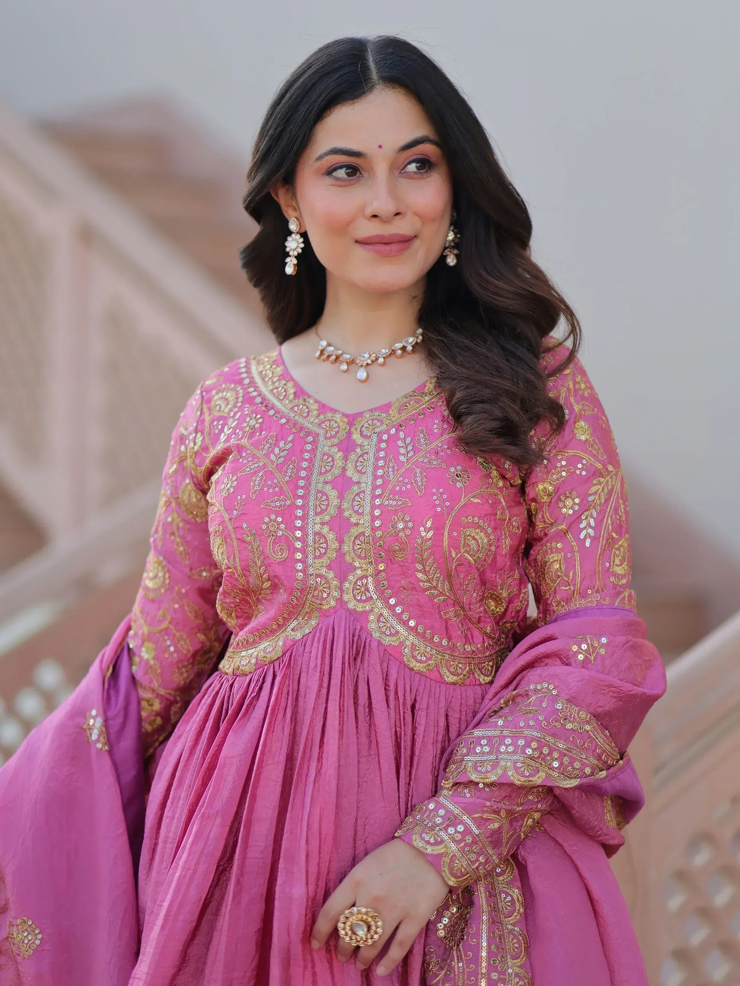 Pink ethnic gown with gold embroidery, perfect for Indian celebrations and festive occasions.