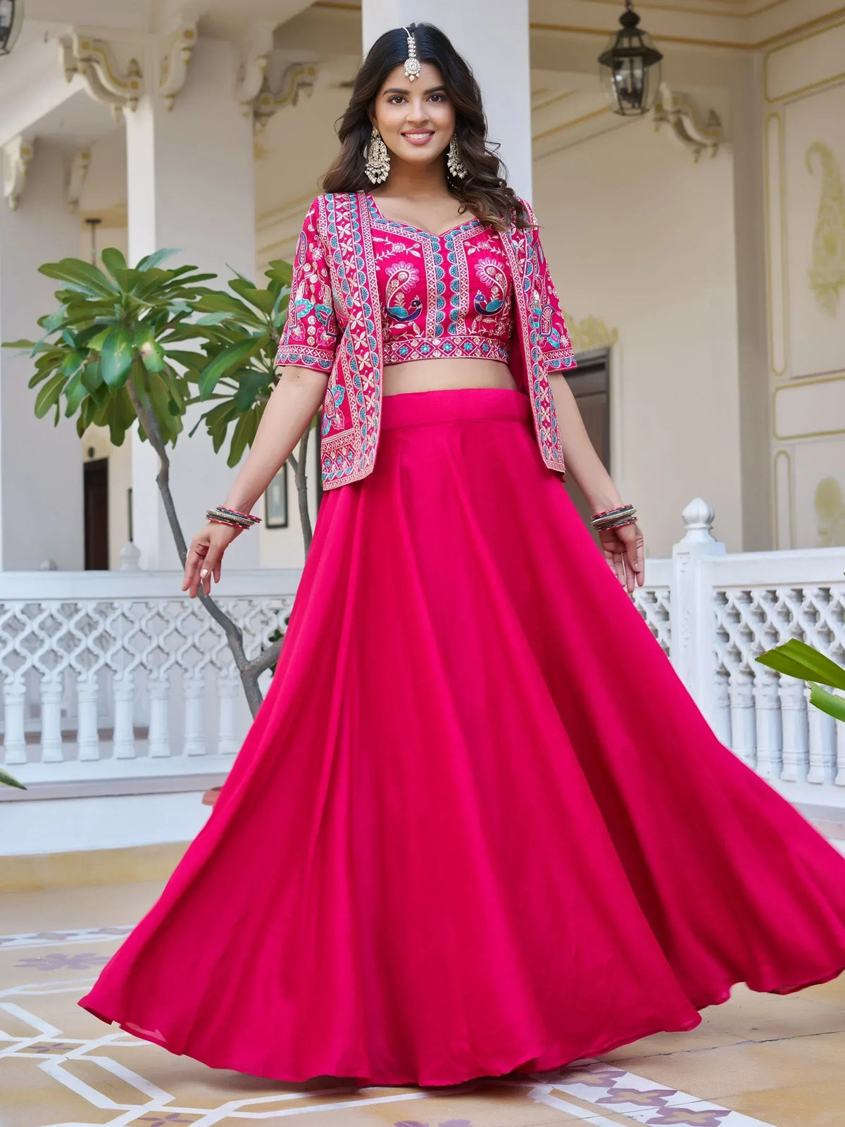 Vibrant pink embroidered lehenga choli with peacock motifs, perfect for Indian ethnic wear occasions