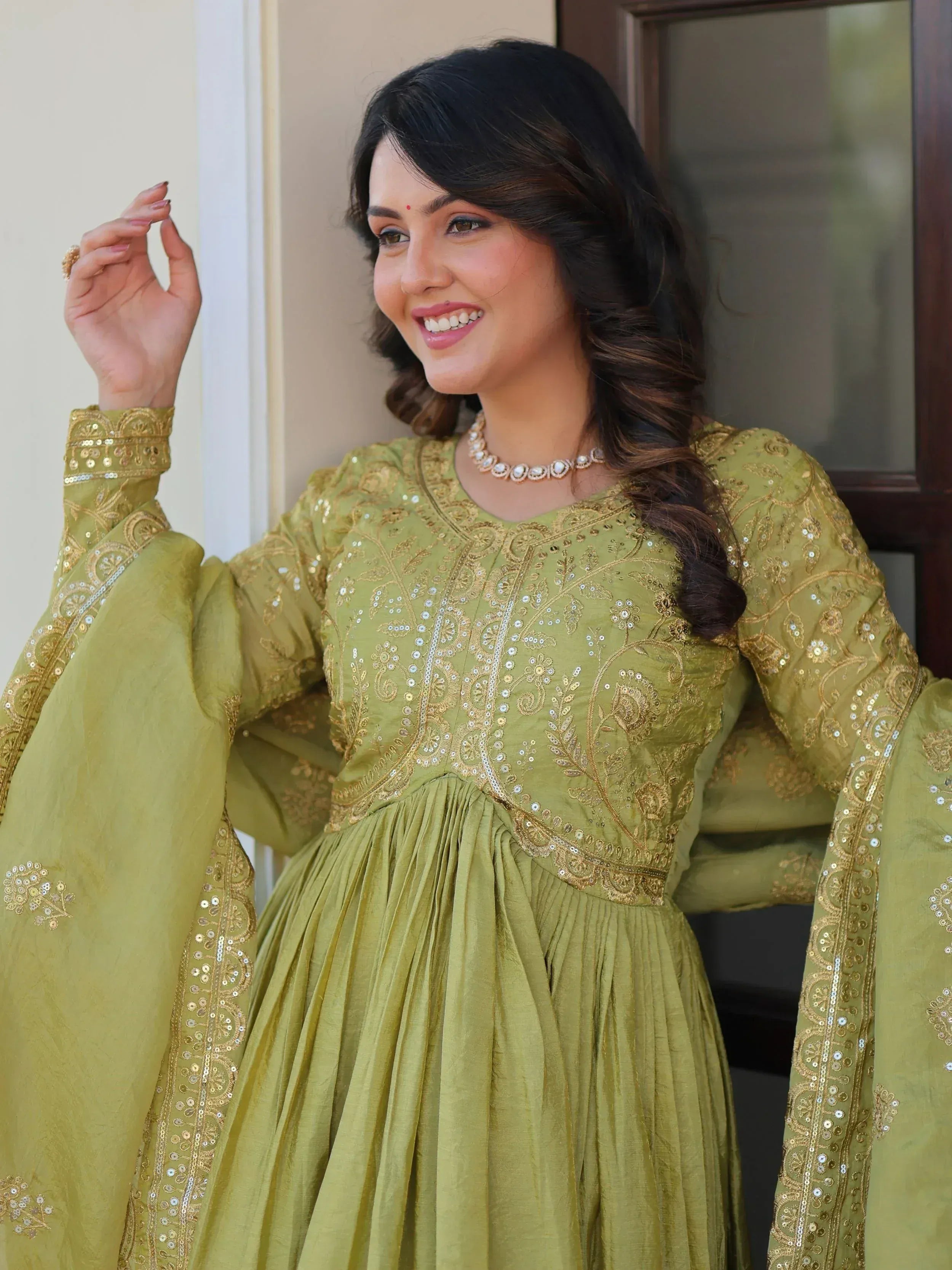 Olive green ethnic gown with gold embroidery and sequins, perfect for Indian festive occasions