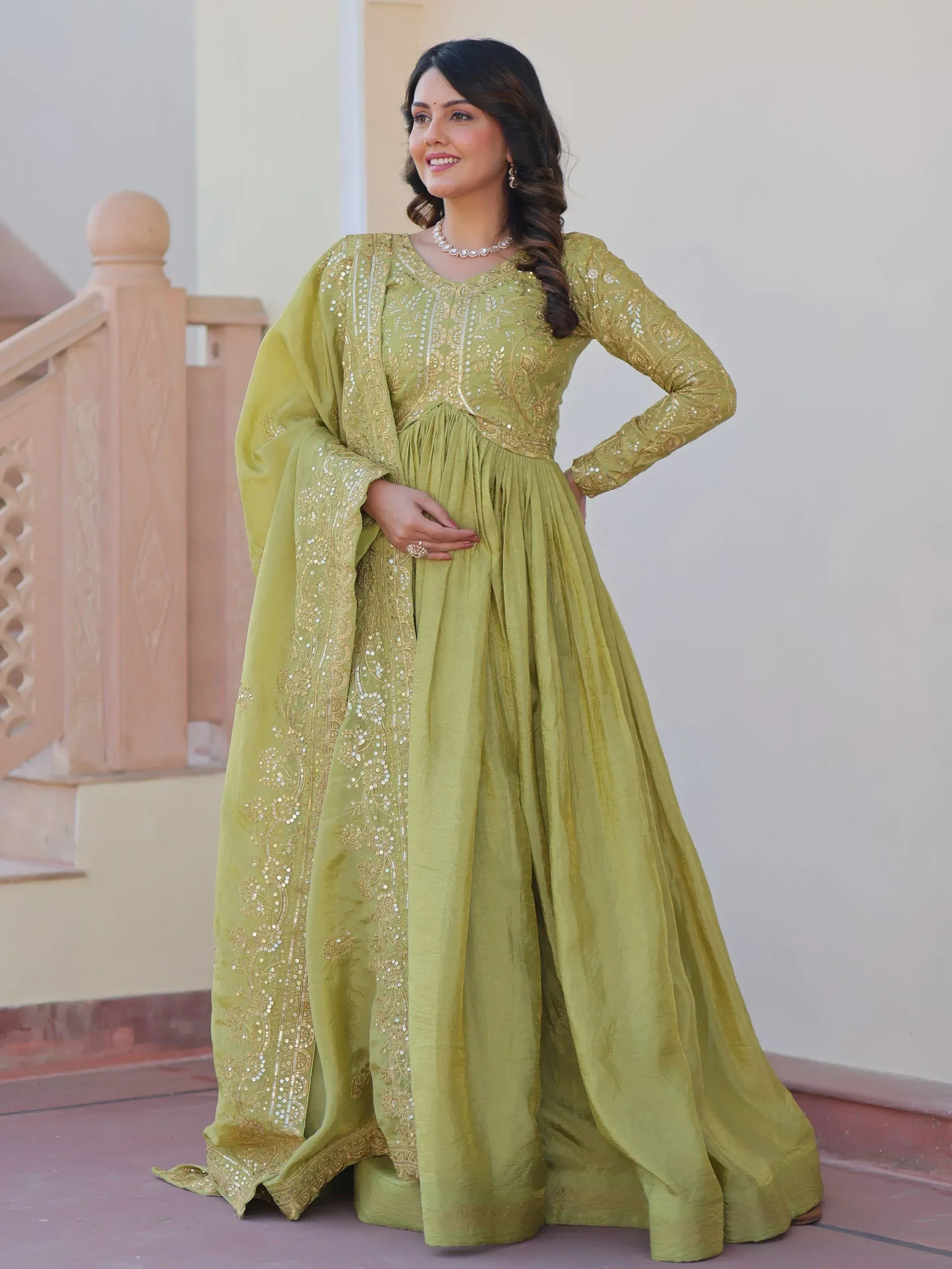 Olive green ethnic gown with gold embroidery and sequins, perfect for Indian occasions