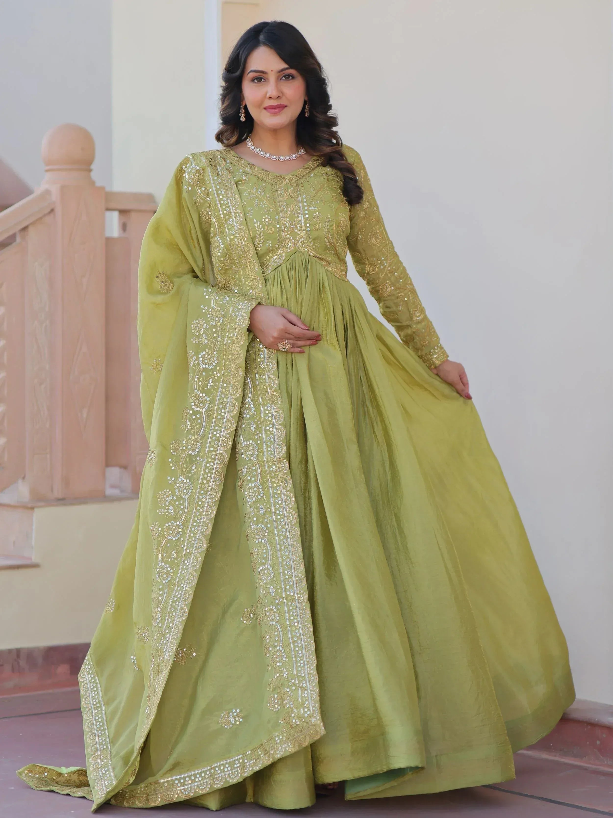 Elegant lime green ethnic gown with gold embroidery, perfect for Indian festive occasions and weddings.