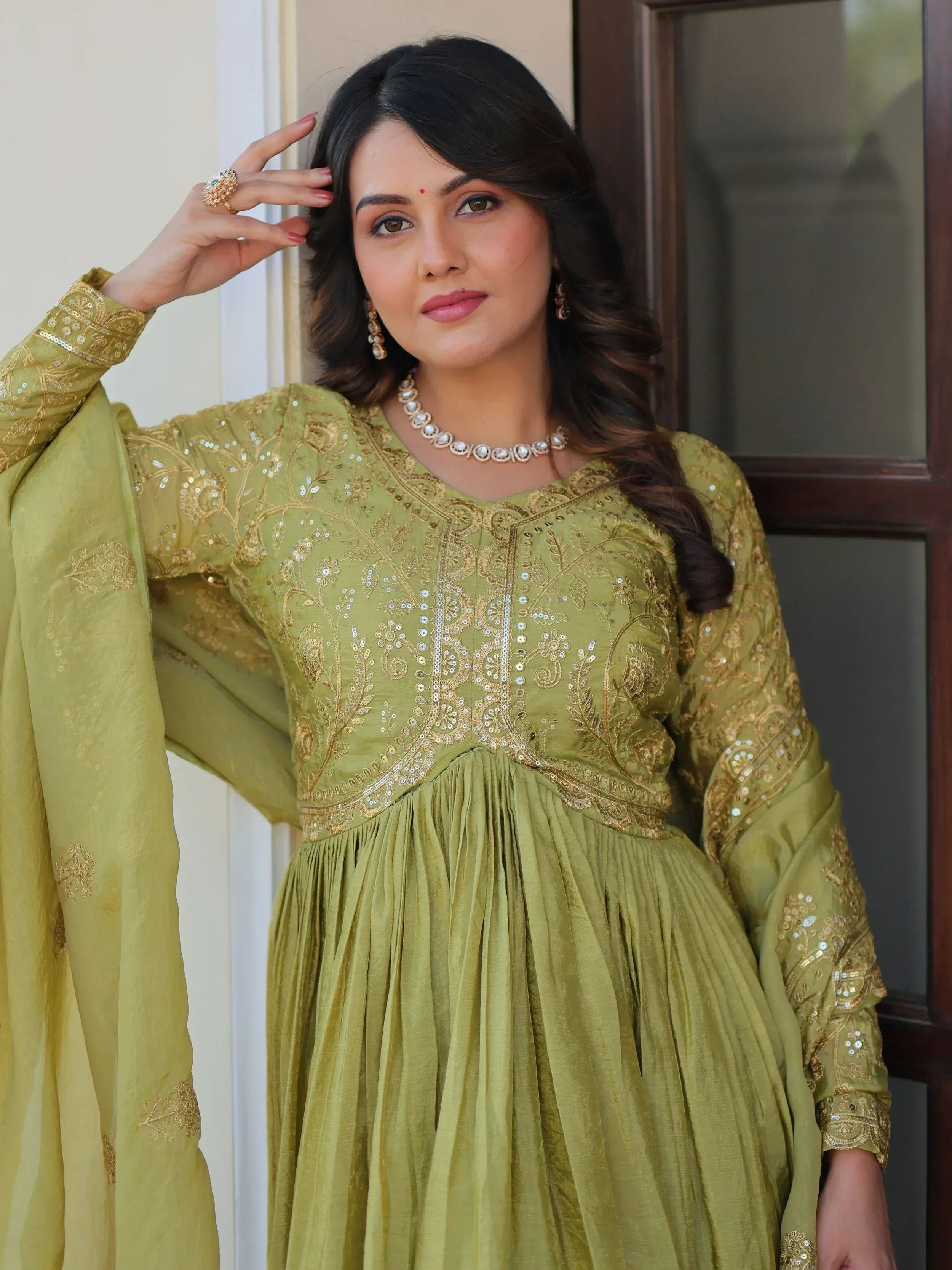 Olive green embroidered ethnic gown with gold detailing, perfect for Indian occasions