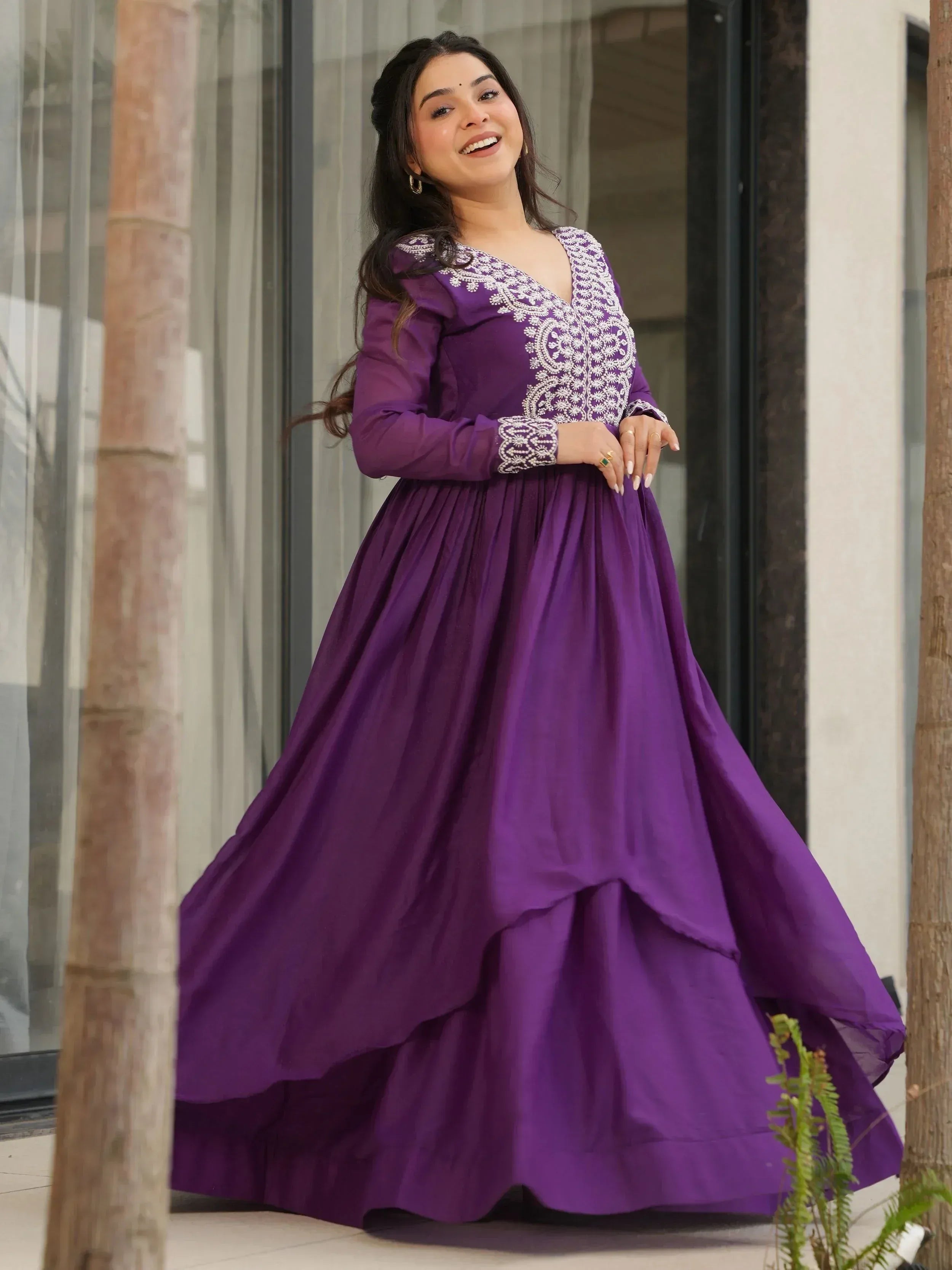Purple ethnic gown with white embroidery, long sleeves, and flared skirt for Indian occasions