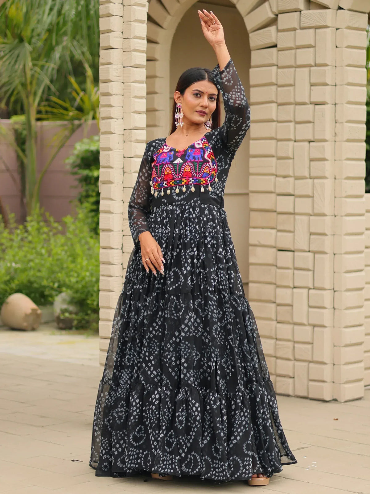 Black ethnic gown with colorful elephant embroidery and tiered skirt, perfect for Indian occasions