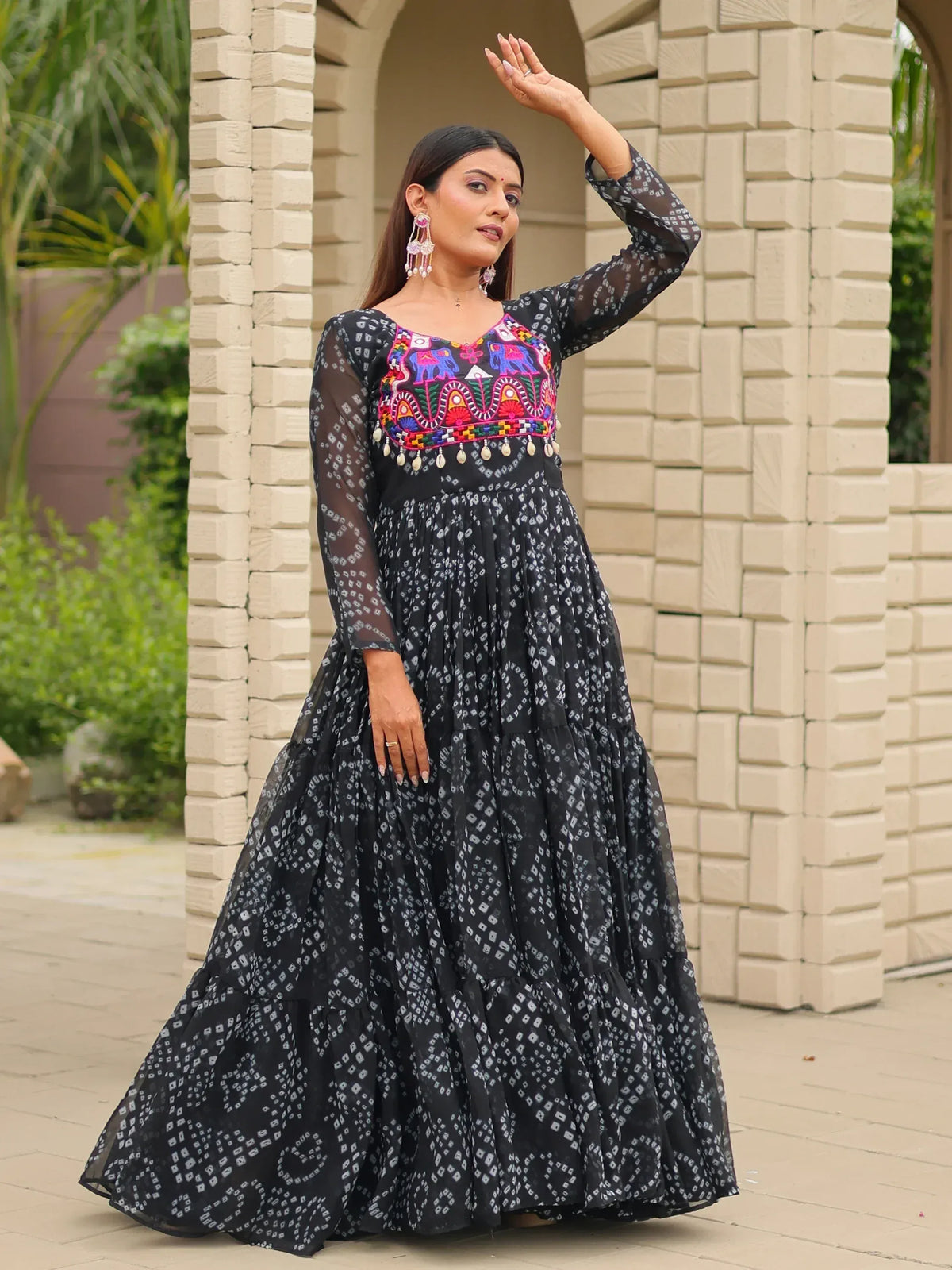 Black ethnic gown with colorful elephant embroidery and tiered skirt, perfect for Indian occasions