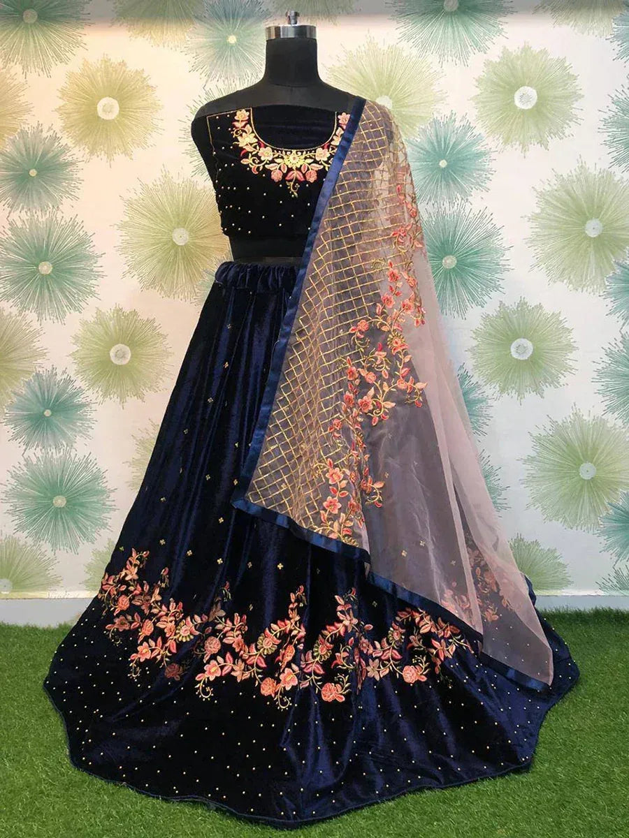 Navy blue velvet lehenga choli with floral embroidery and sheer dupatta, perfect for Indian ethnic wear events