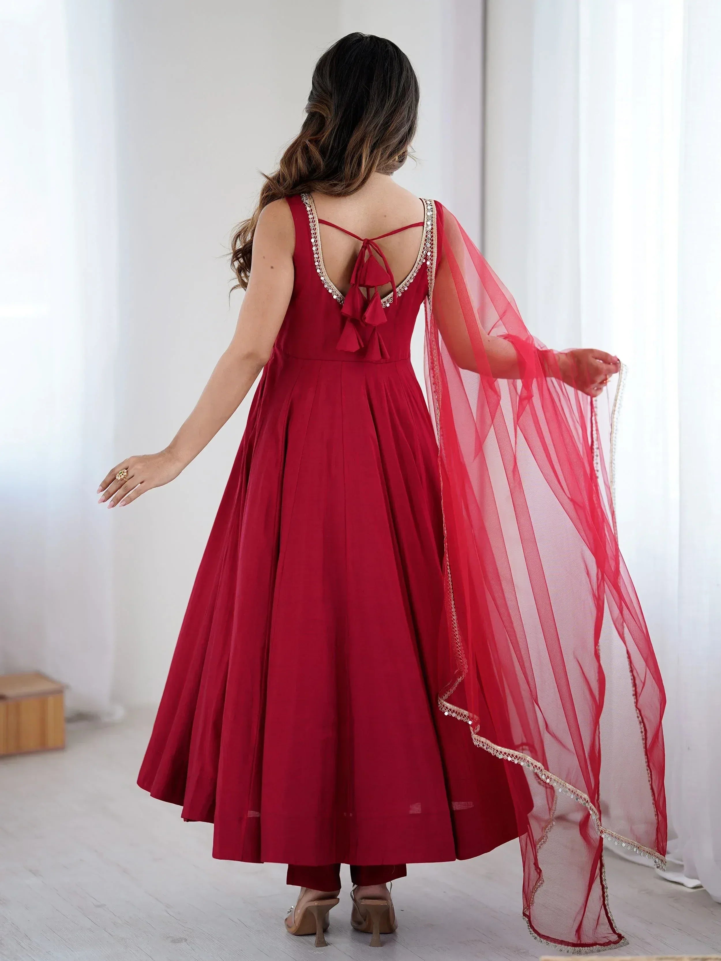Red ethnic gown with back tie detail and sheer dupatta, perfect for Indian occasions