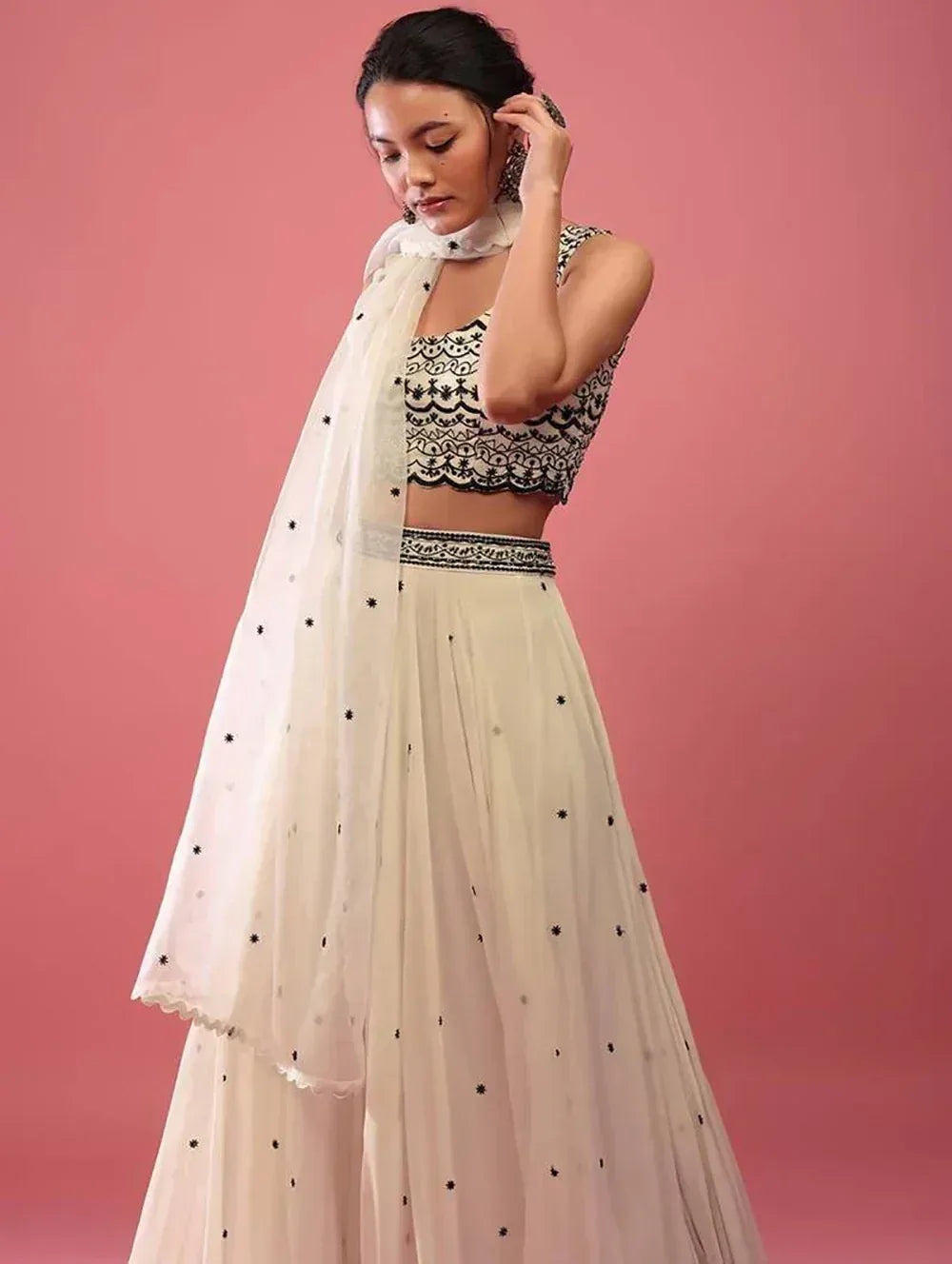Elegant white lehenga choli with black embroidery and sheer dupatta, perfect for Indian ethnic occasions