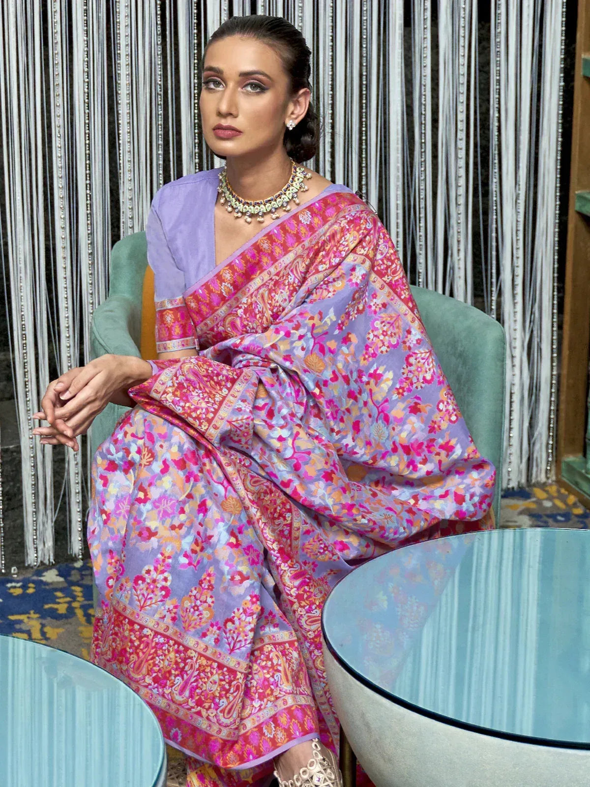 Woman in vibrant floral saree with purple blouse, traditional Indian ethnic wear, elegant designer look