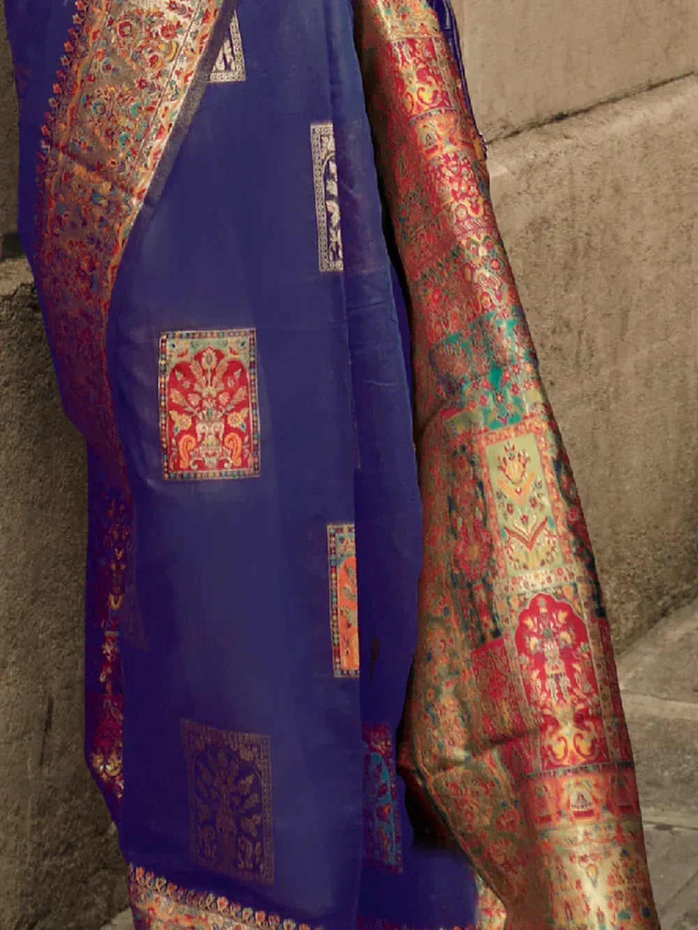 Blue and red embroidered Indian saree with intricate gold patterns and traditional motifs
