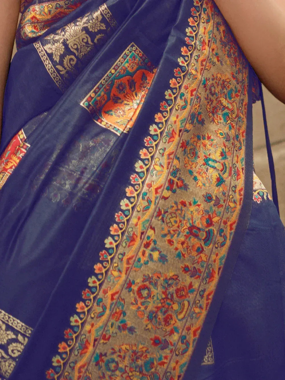 Blue ethnic saree with intricate gold and floral border, perfect for Indian weddings and festive occasions