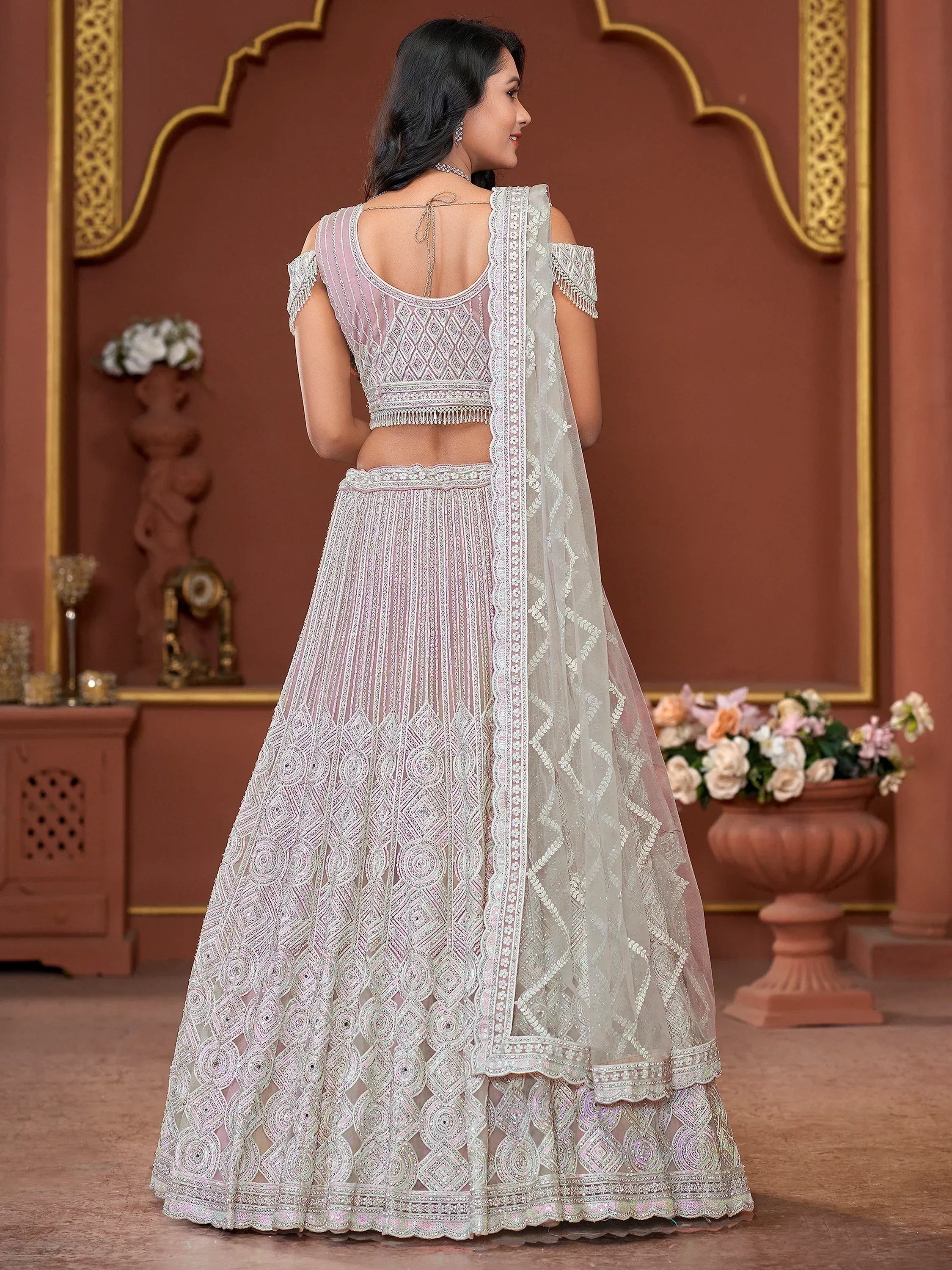 Elegant white embroidered lehenga choli with open back blouse and sheer dupatta, perfect for Indian weddings