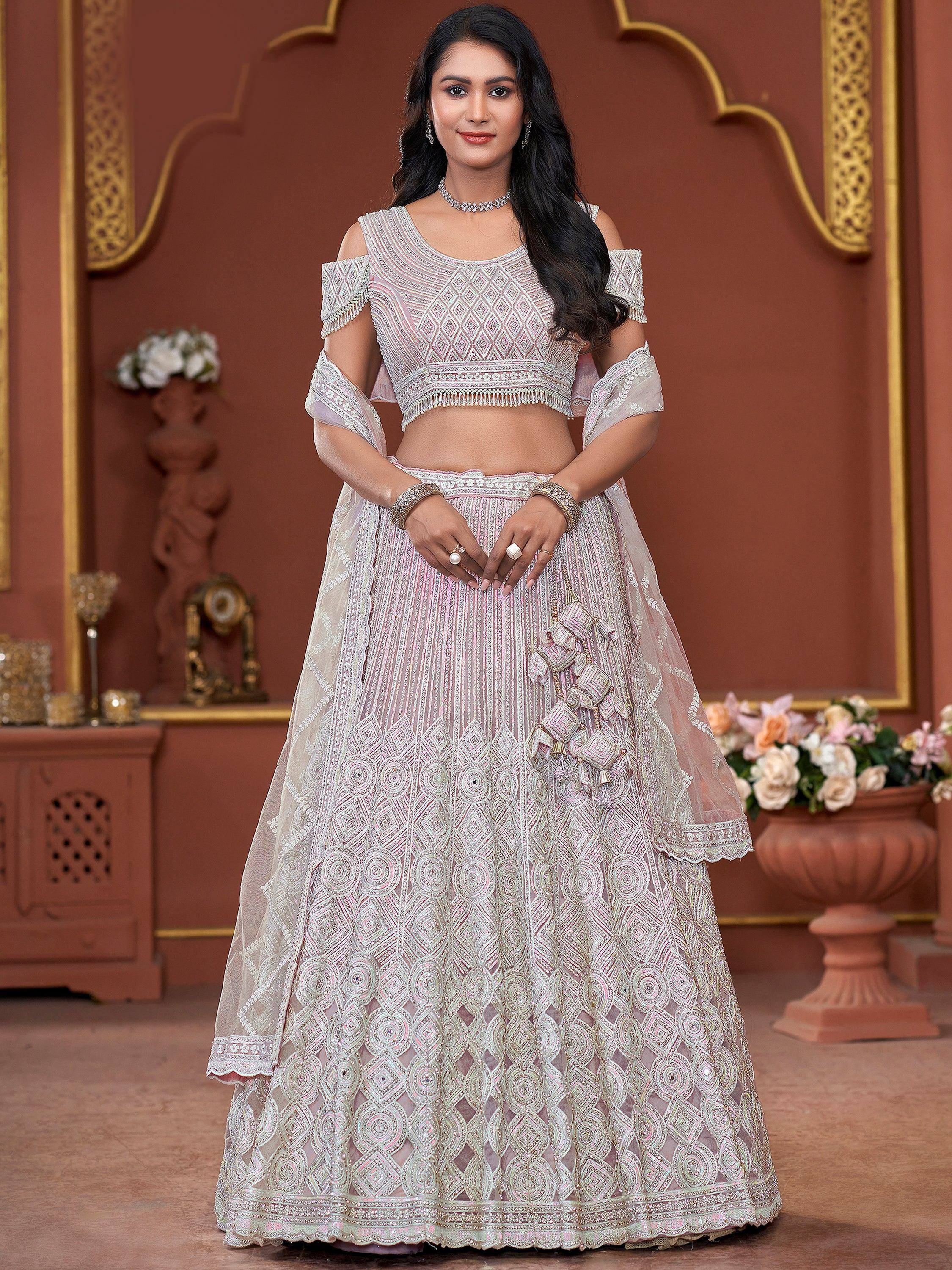 Elegant pink and white embroidered lehenga choli with off-shoulder blouse, perfect for Indian weddings and festivals.
