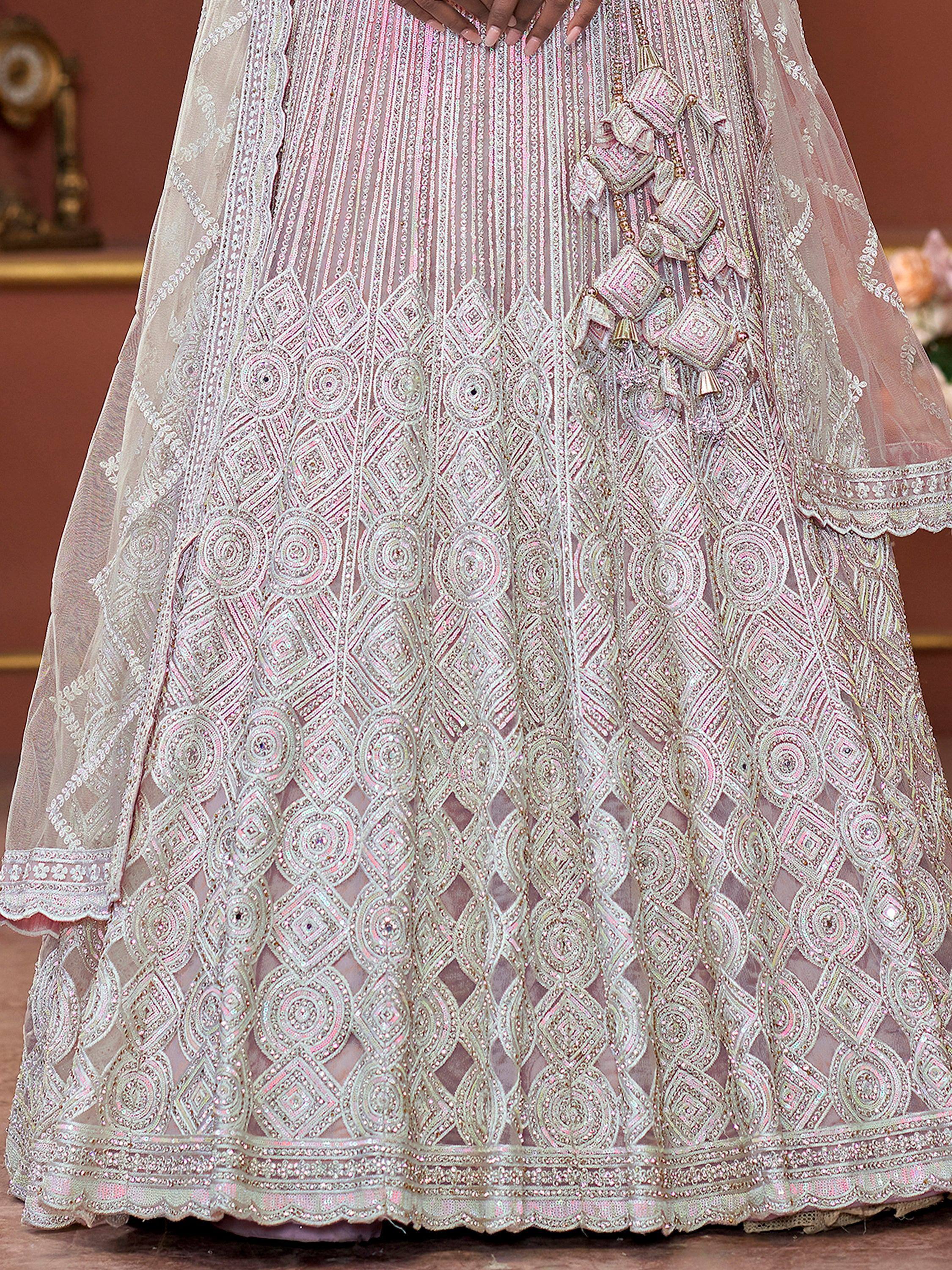 Elegant pink and silver embroidered lehenga choli with intricate geometric patterns and tassel details