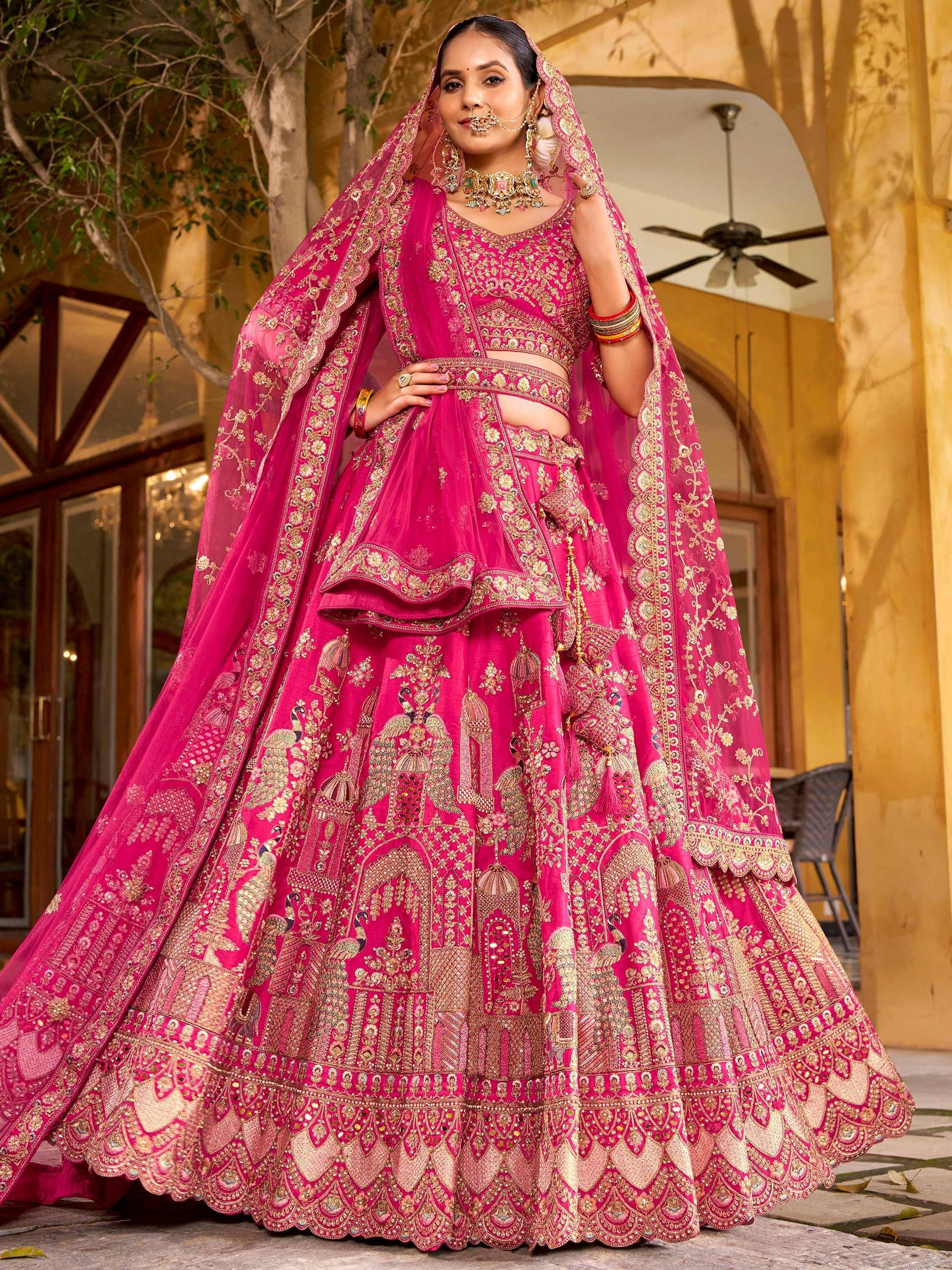 Pink designer lehenga choli with gold embroidery, perfect for Indian weddings and festive occasions.