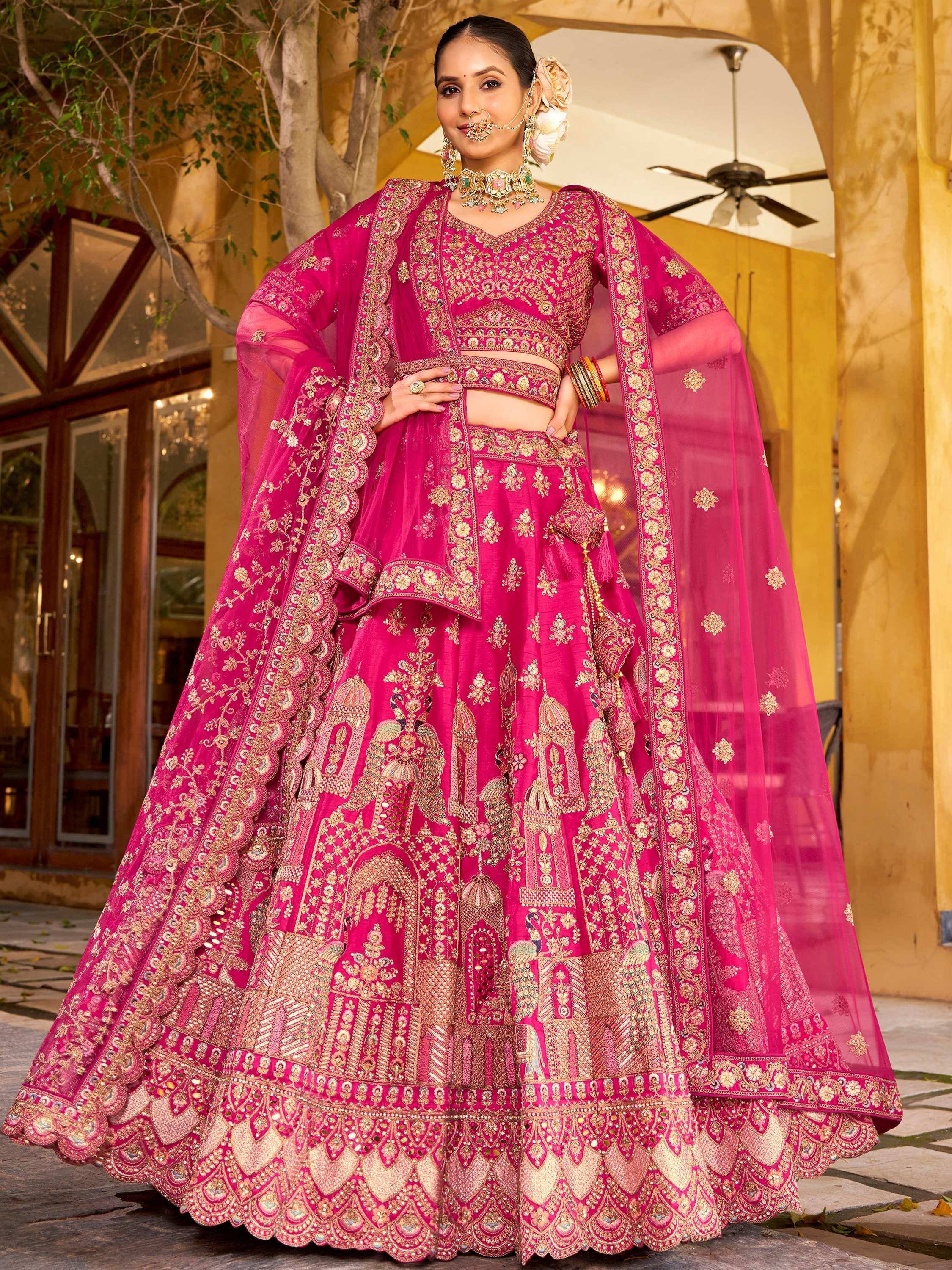 Pink designer lehenga choli with gold embroidery, perfect for Indian weddings and festive occasions.