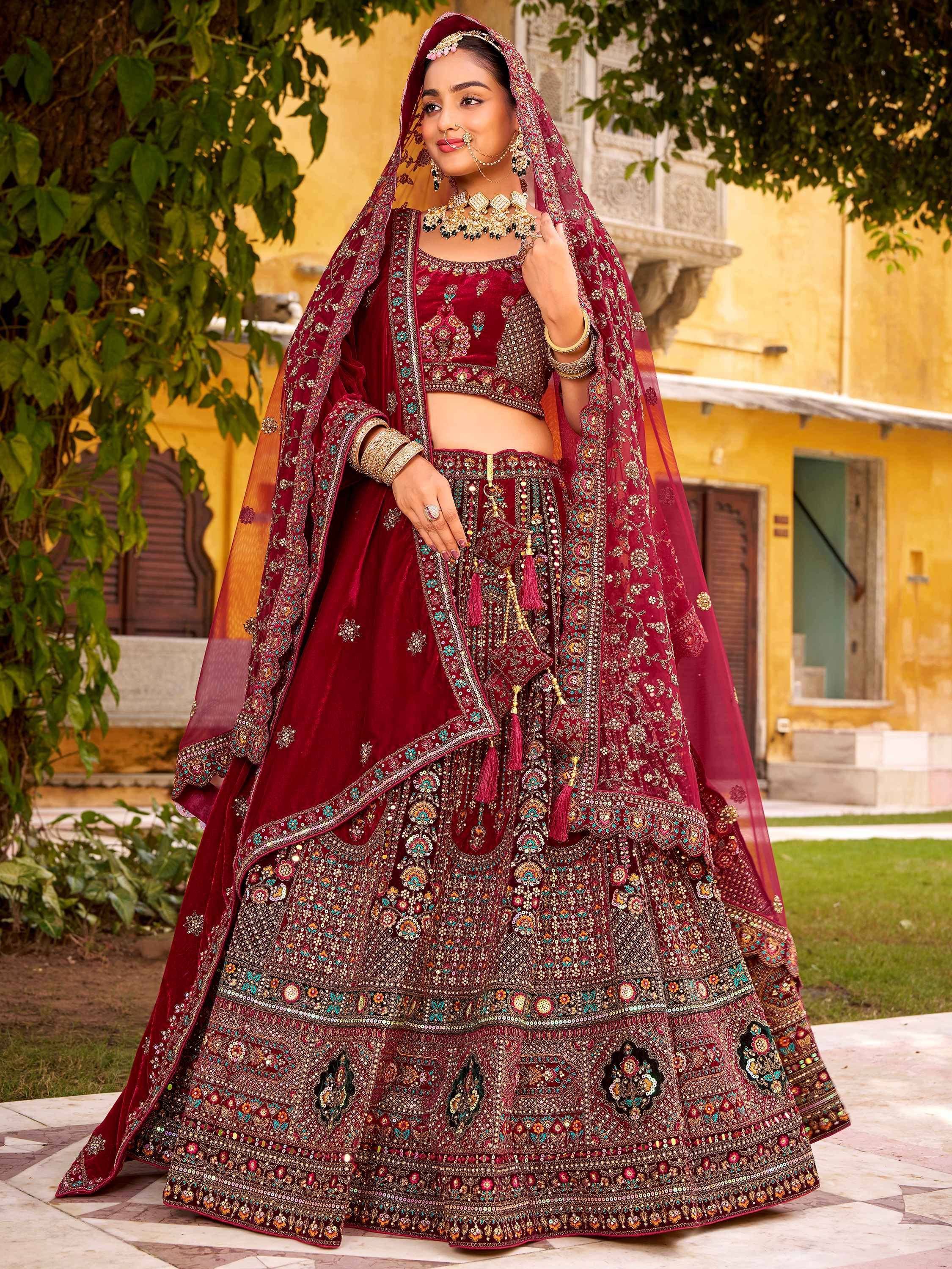 Maroon velvet designer lehenga choli with heavy embroidery and dupatta, perfect for Indian weddings and festive occasions