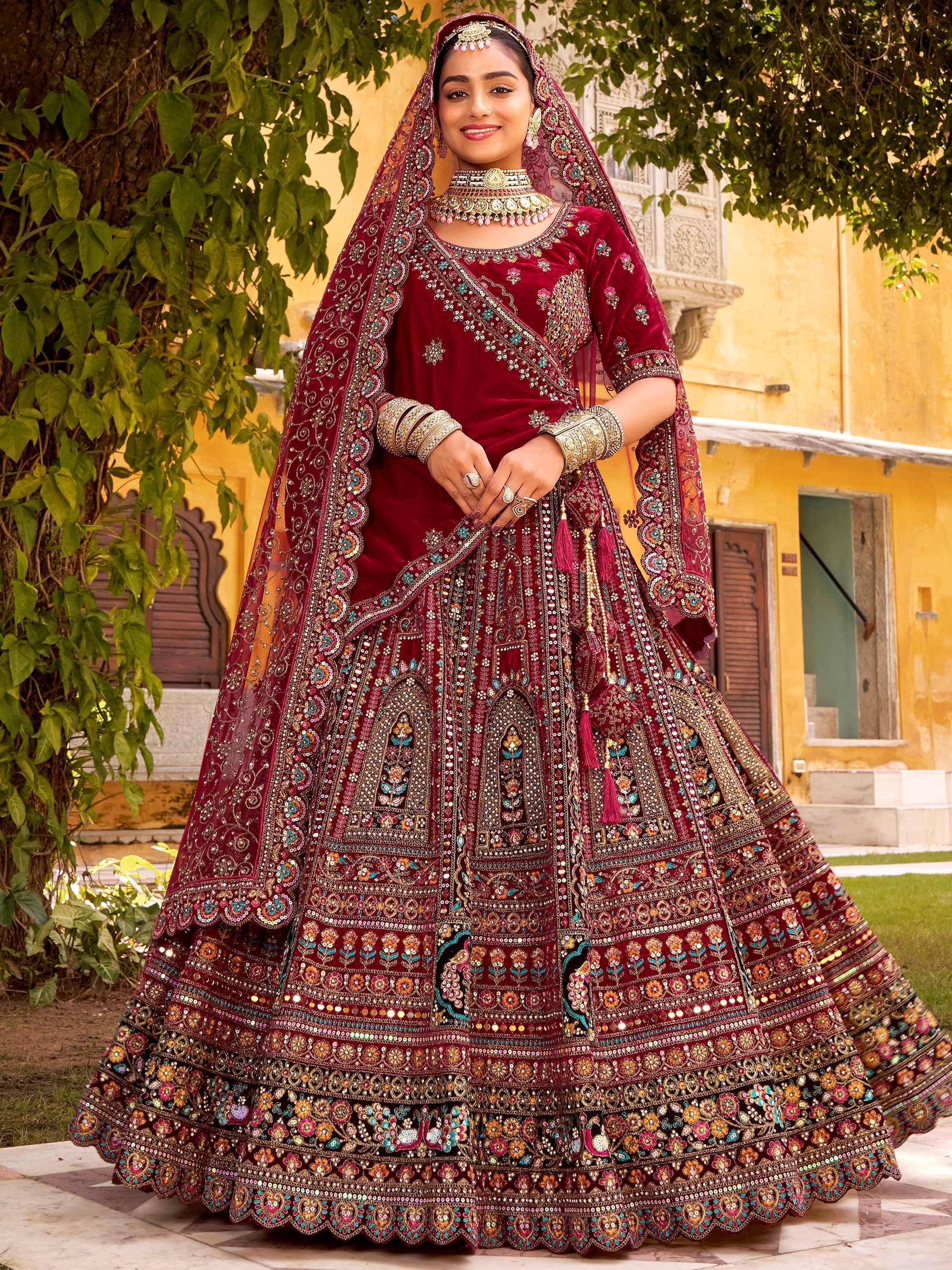 Maroon velvet bridal lehenga choli with heavy embroidery and dupatta, perfect for Indian weddings