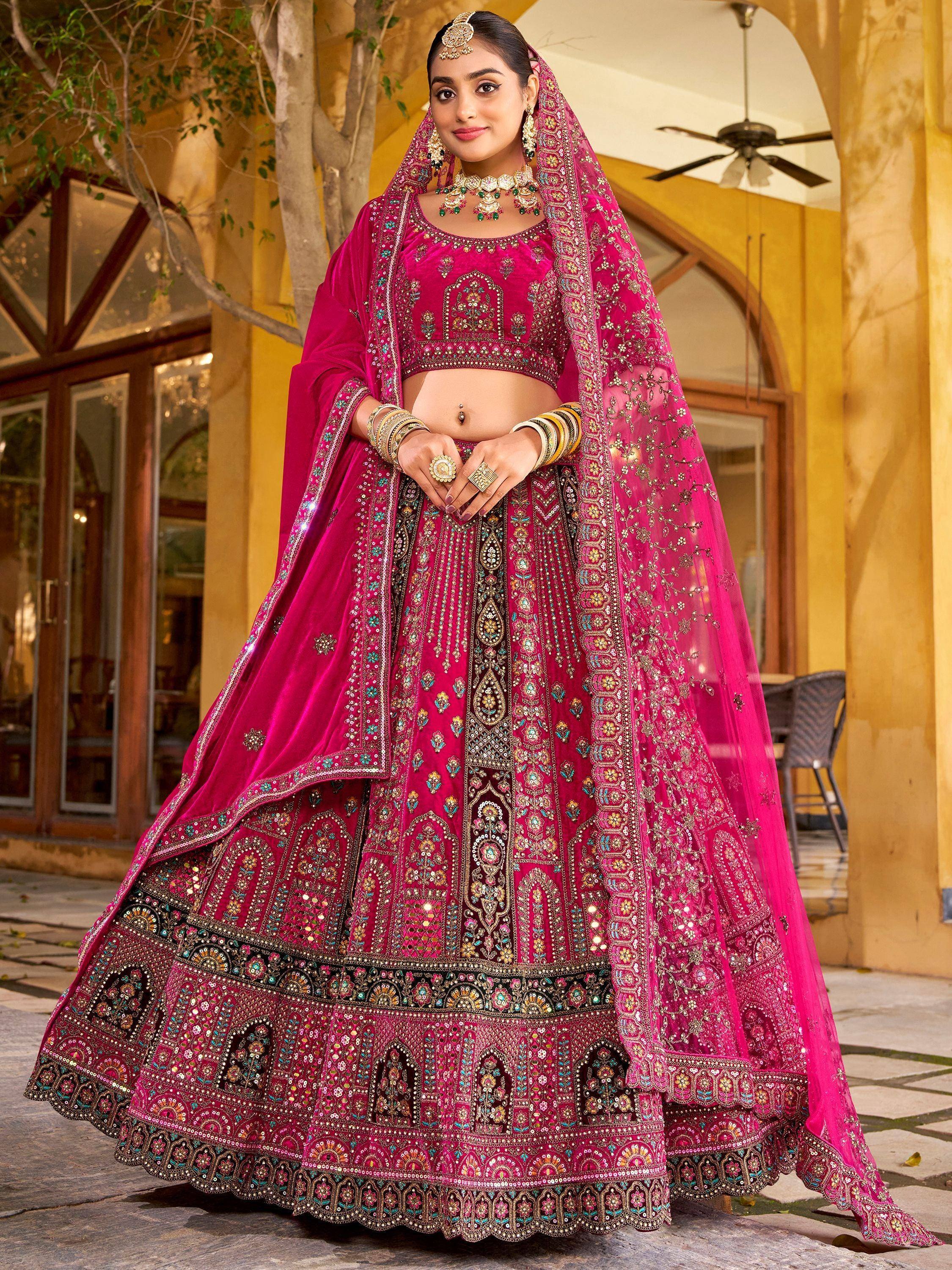 Fuchsia designer lehenga choli with heavy embroidery, perfect for Indian weddings and festive occasions.