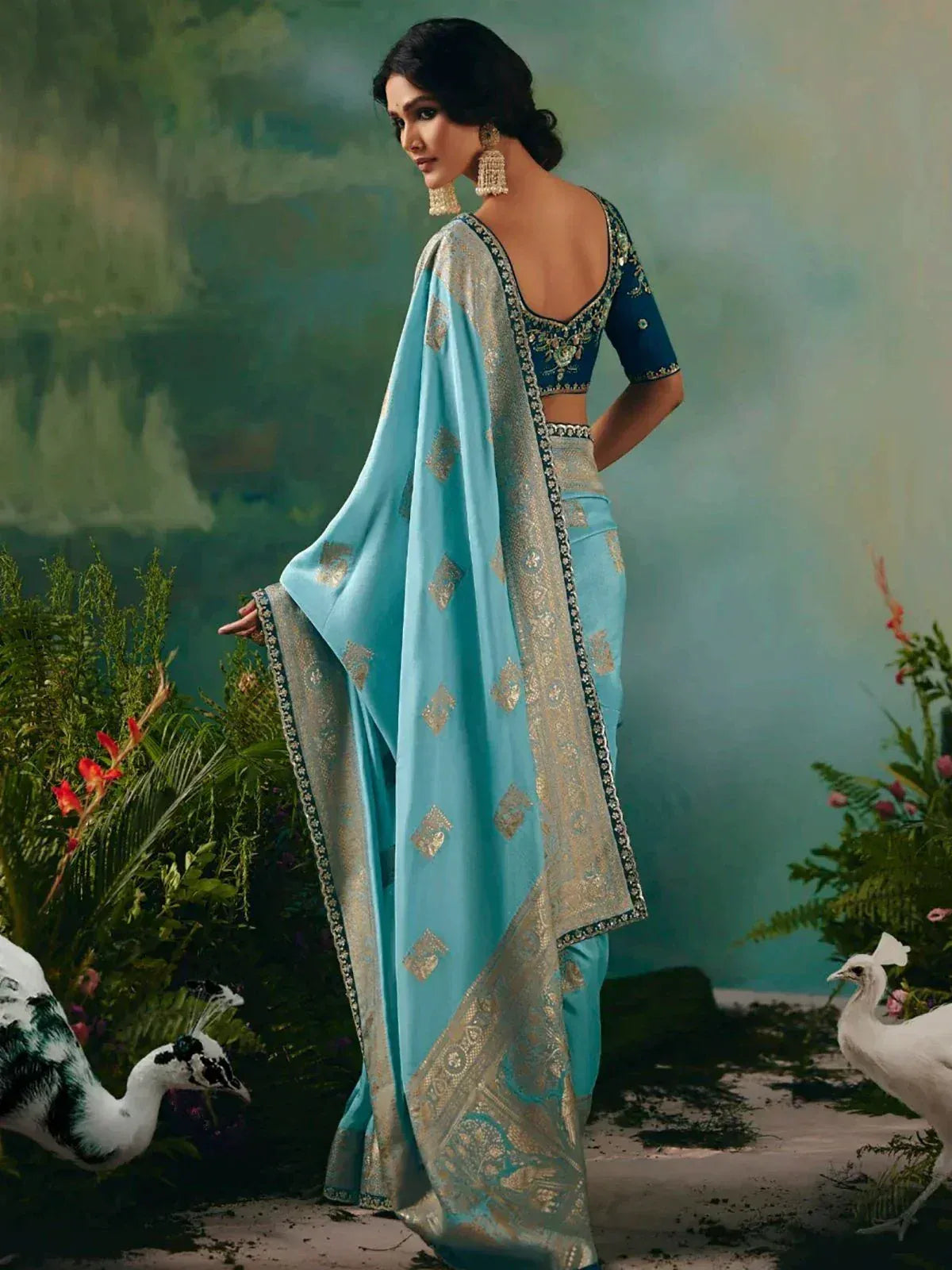 Elegant blue saree with gold embroidery, designer blouse, and peacock motifs for Indian ethnic wear