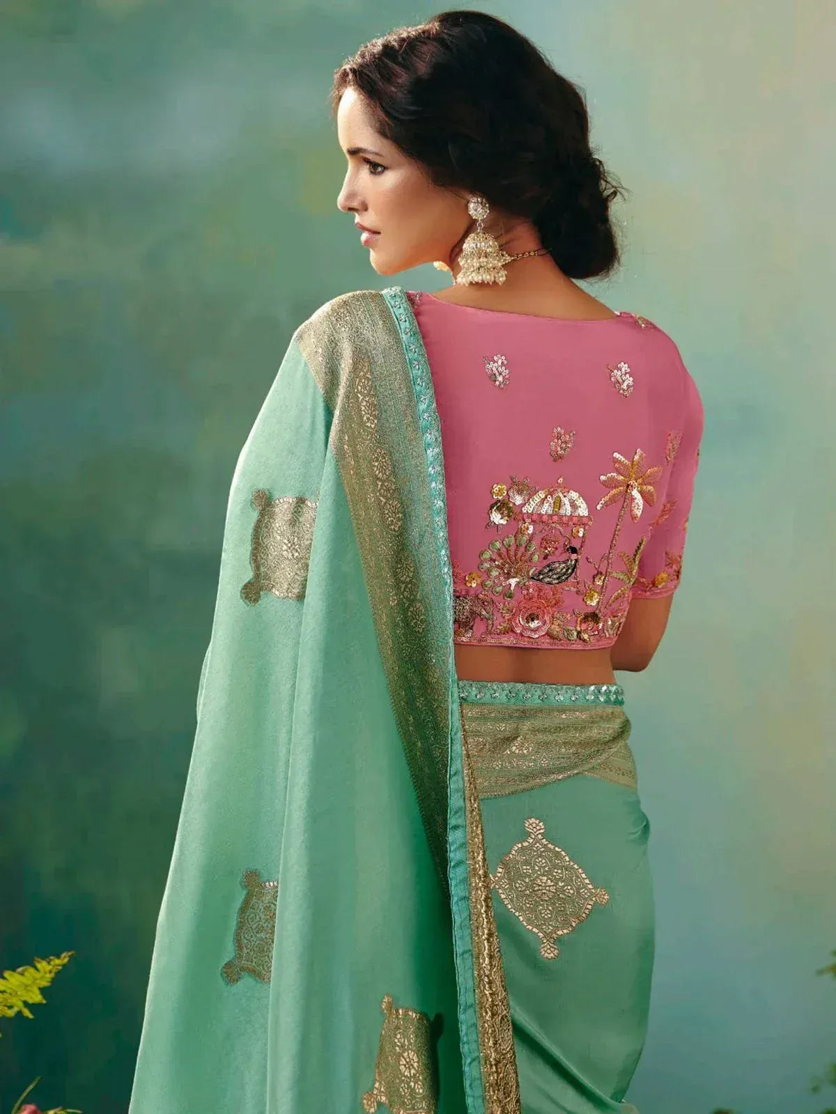 Pink embroidered blouse with mint green saree, floral and peacock motifs, ethnic Indian wear