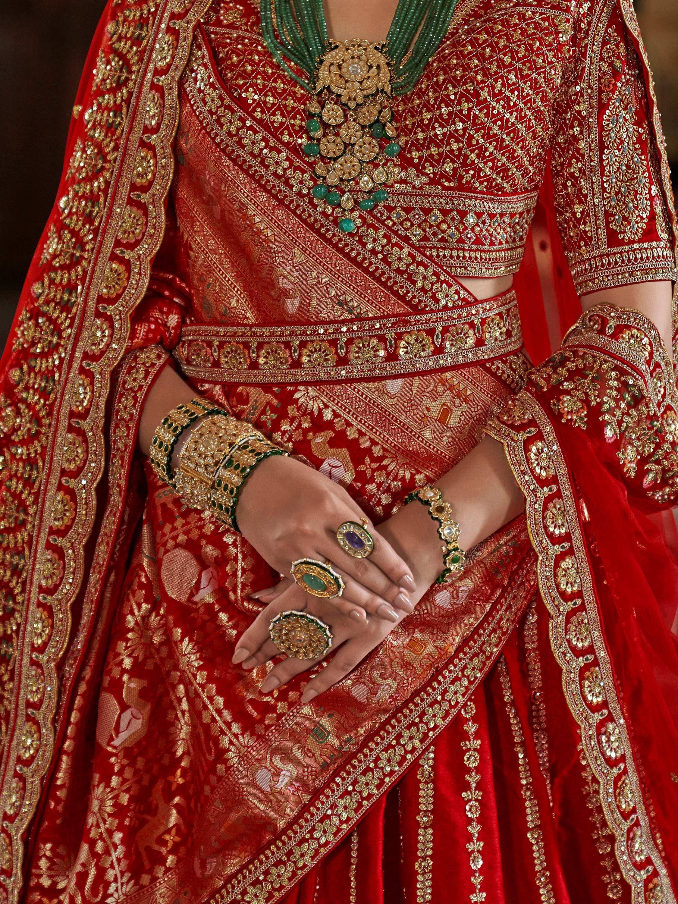 Red bridal lehenga choli with gold embroidery and green jewelry, Indian ethnic wear