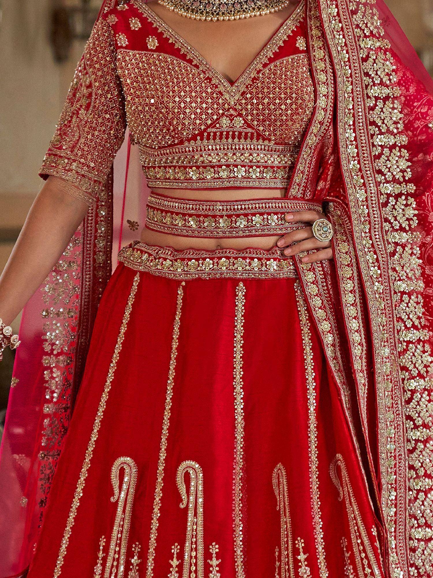Red designer lehenga choli with gold embroidery and sequin work, perfect for weddings and ethnic events.