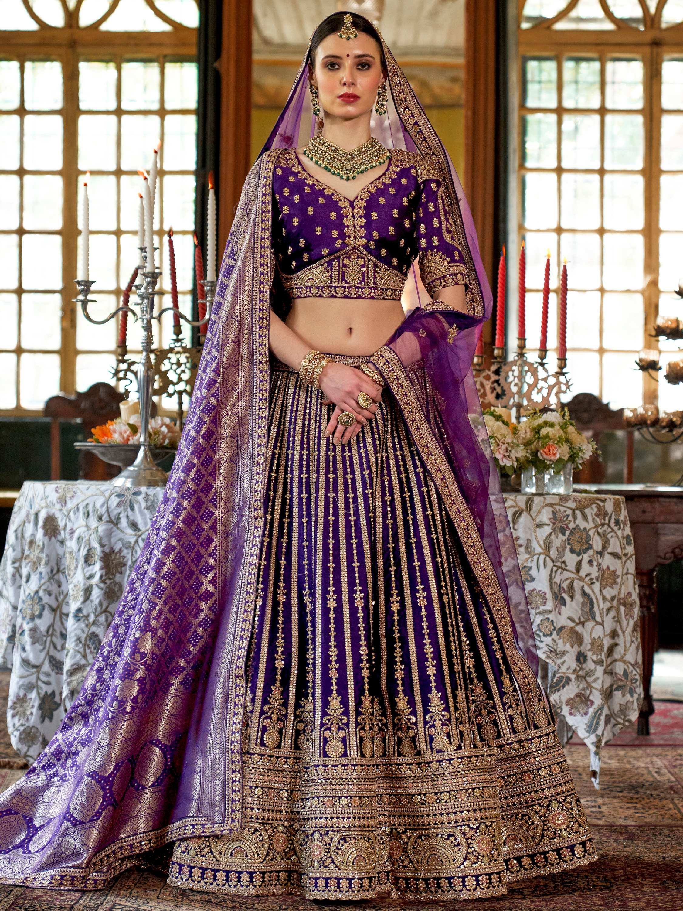 Purple designer lehenga choli with gold embroidery, perfect for Indian weddings and ethnic events.