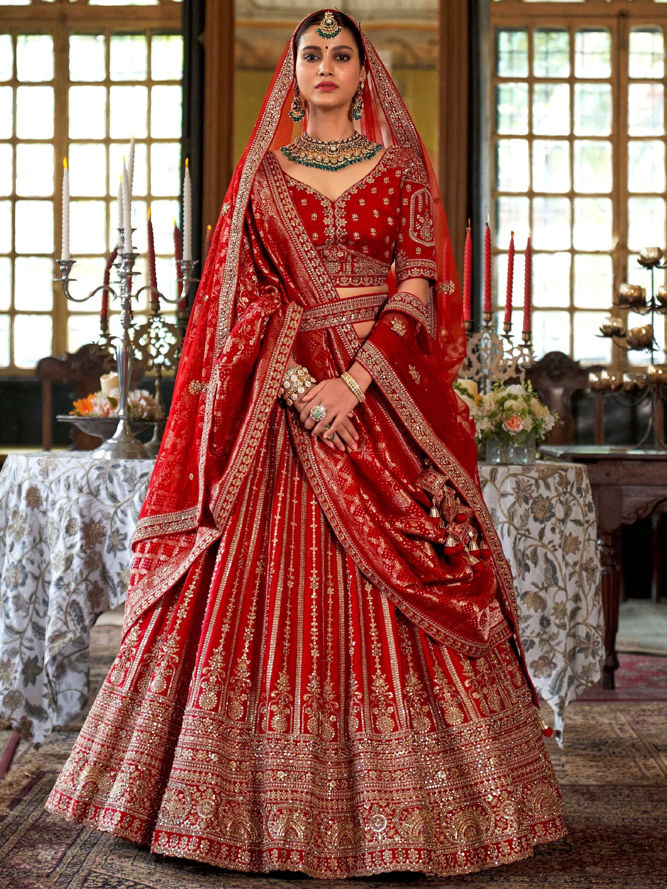 Red bridal lehenga choli with gold embroidery, perfect for Indian weddings and ethnic celebrations.