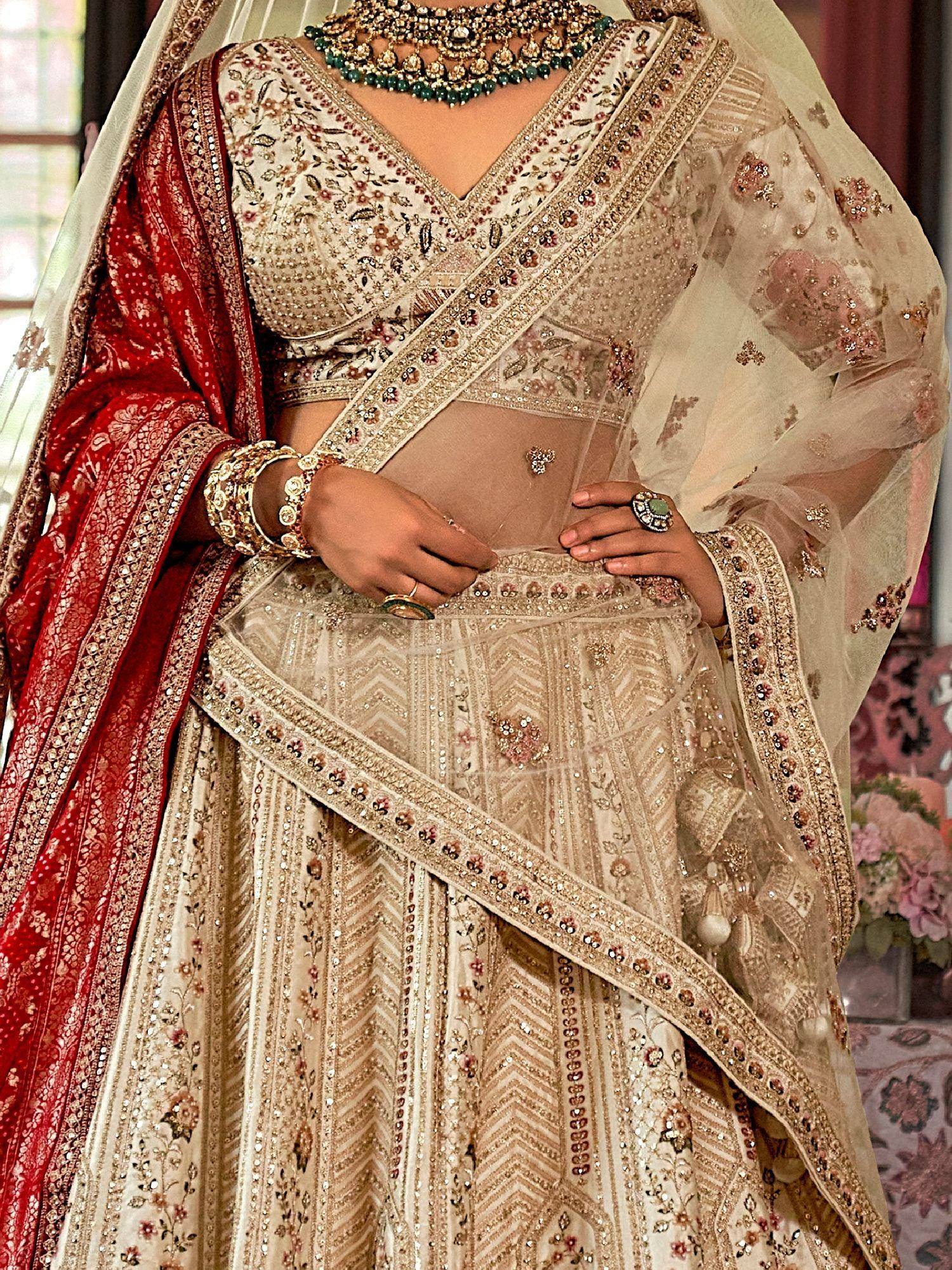 Elegant beige embroidered lehenga choli with red dupatta, perfect for Indian weddings and festive occasions.