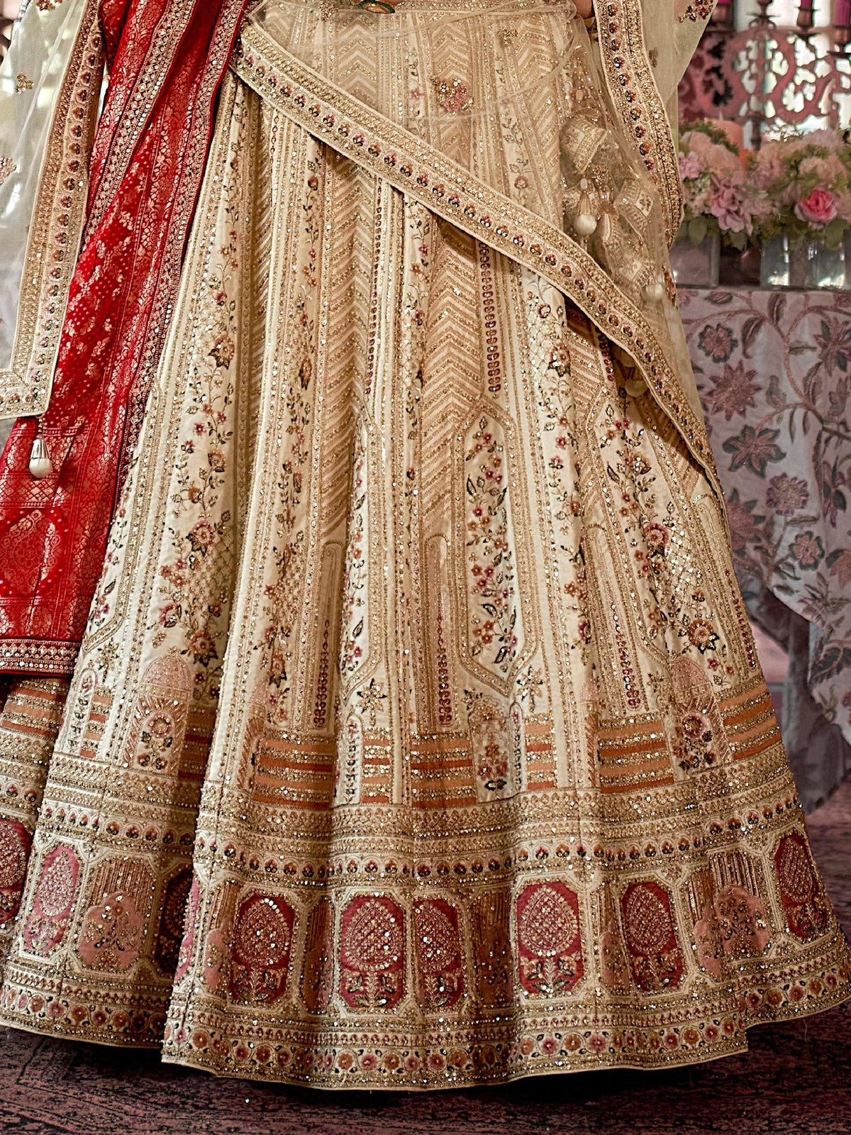 Designer beige lehenga choli with intricate gold embroidery and red dupatta, perfect for Indian weddings