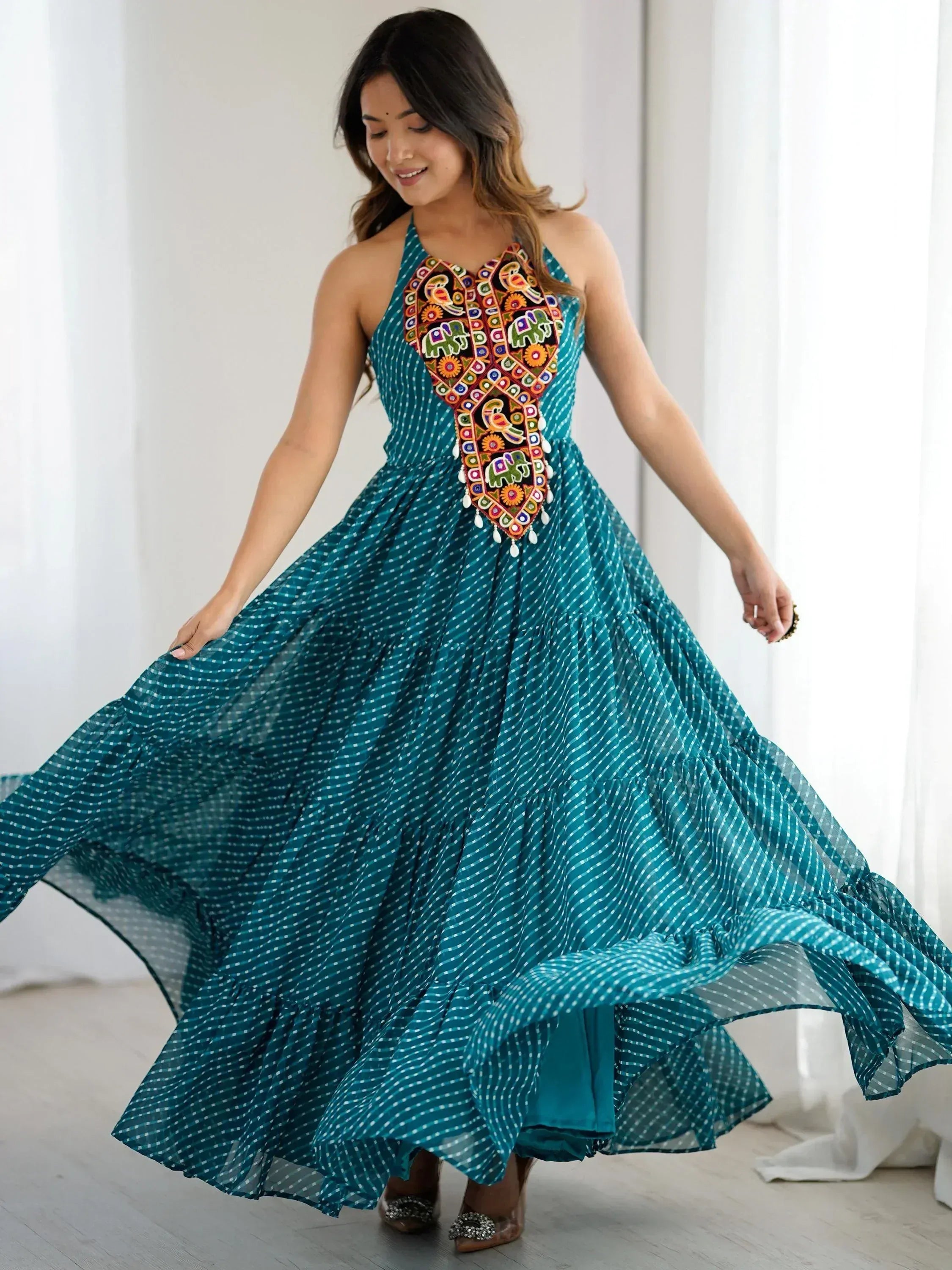 Teal ethnic gown with colorful embroidery, perfect for Indian festive occasions and events.