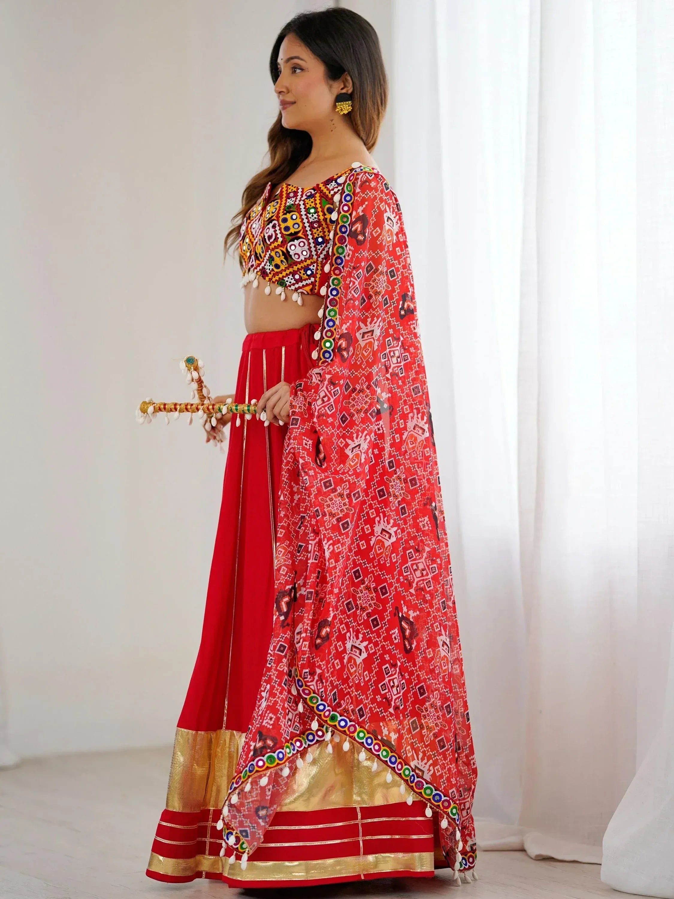Red ethnic lehenga choli with mirror work and printed dupatta, perfect for festive occasions