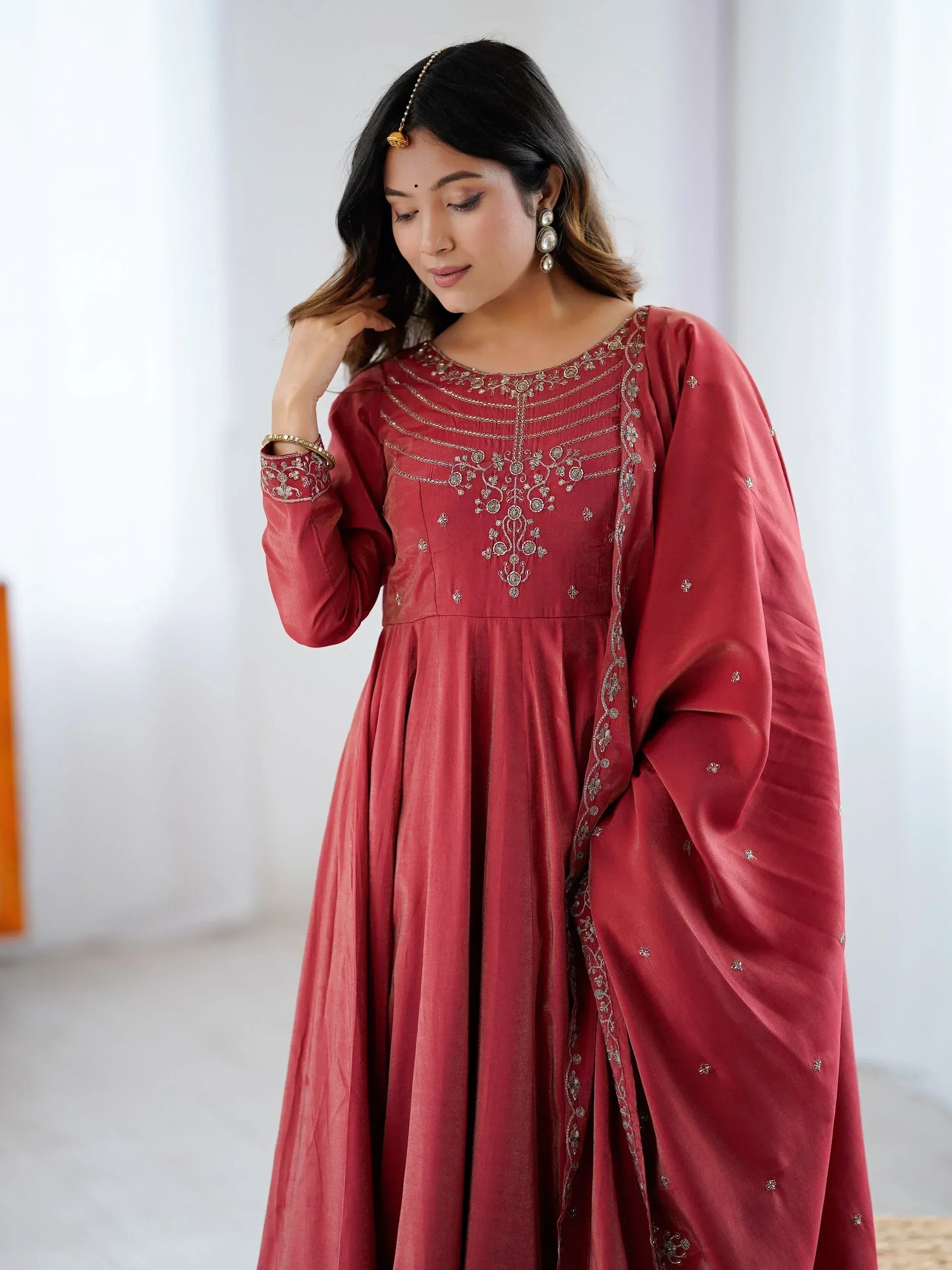 Red ethnic gown with gold embroidery, perfect for Indian occasions and festive wear.