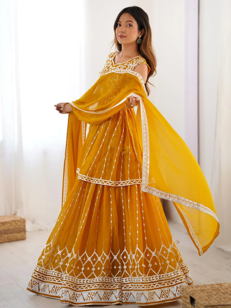 Yellow designer lehenga choli with white embroidery and sequins, perfect for Indian ethnic wear occasions.