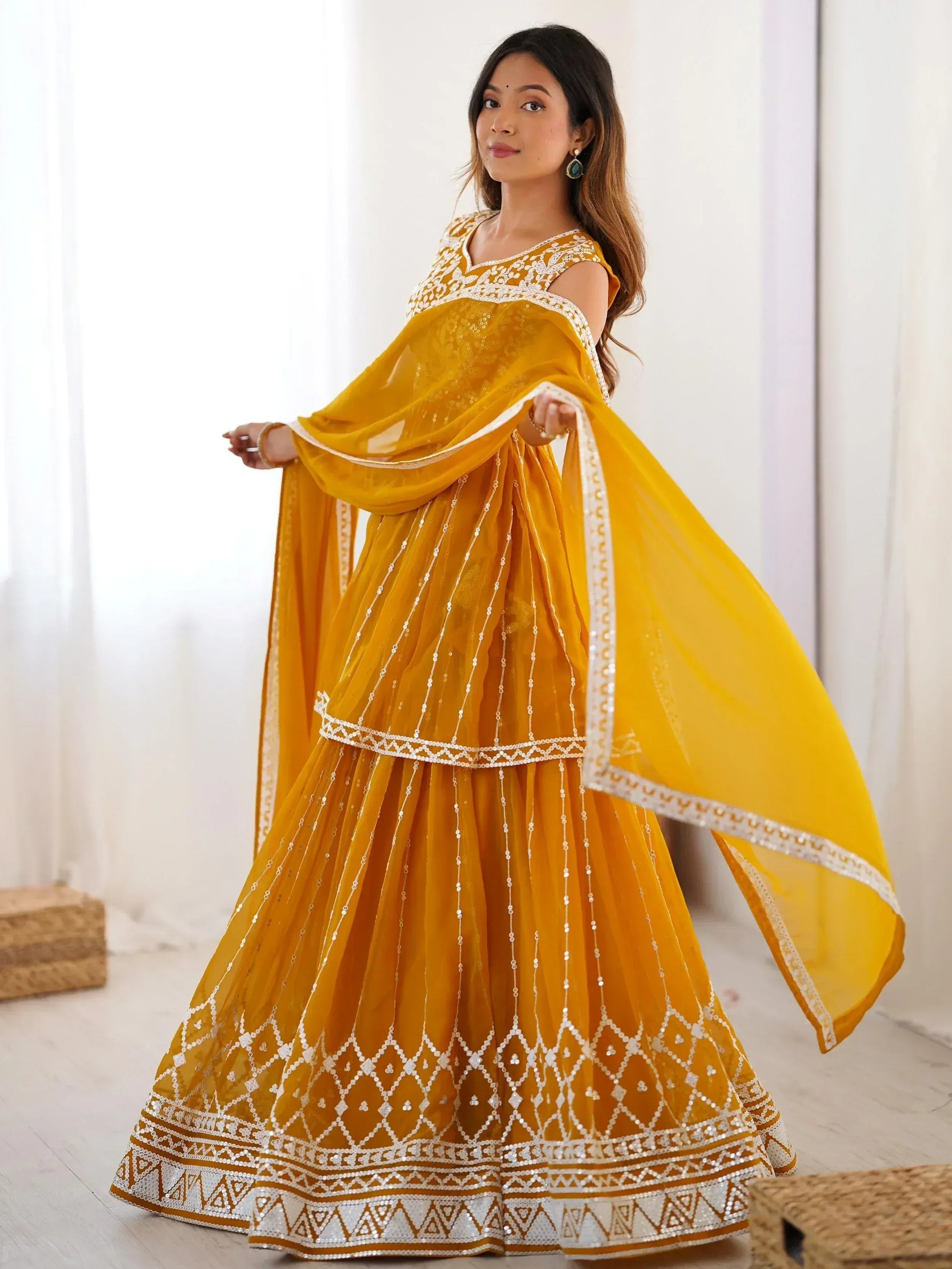 Yellow designer lehenga choli with white embroidery and sequins, perfect for Indian ethnic wear occasions.