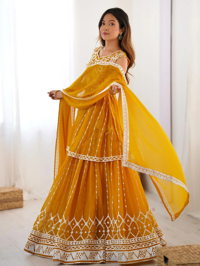 Yellow ethnic lehenga choli with white embroidery and sequins, perfect for Indian weddings and festivals