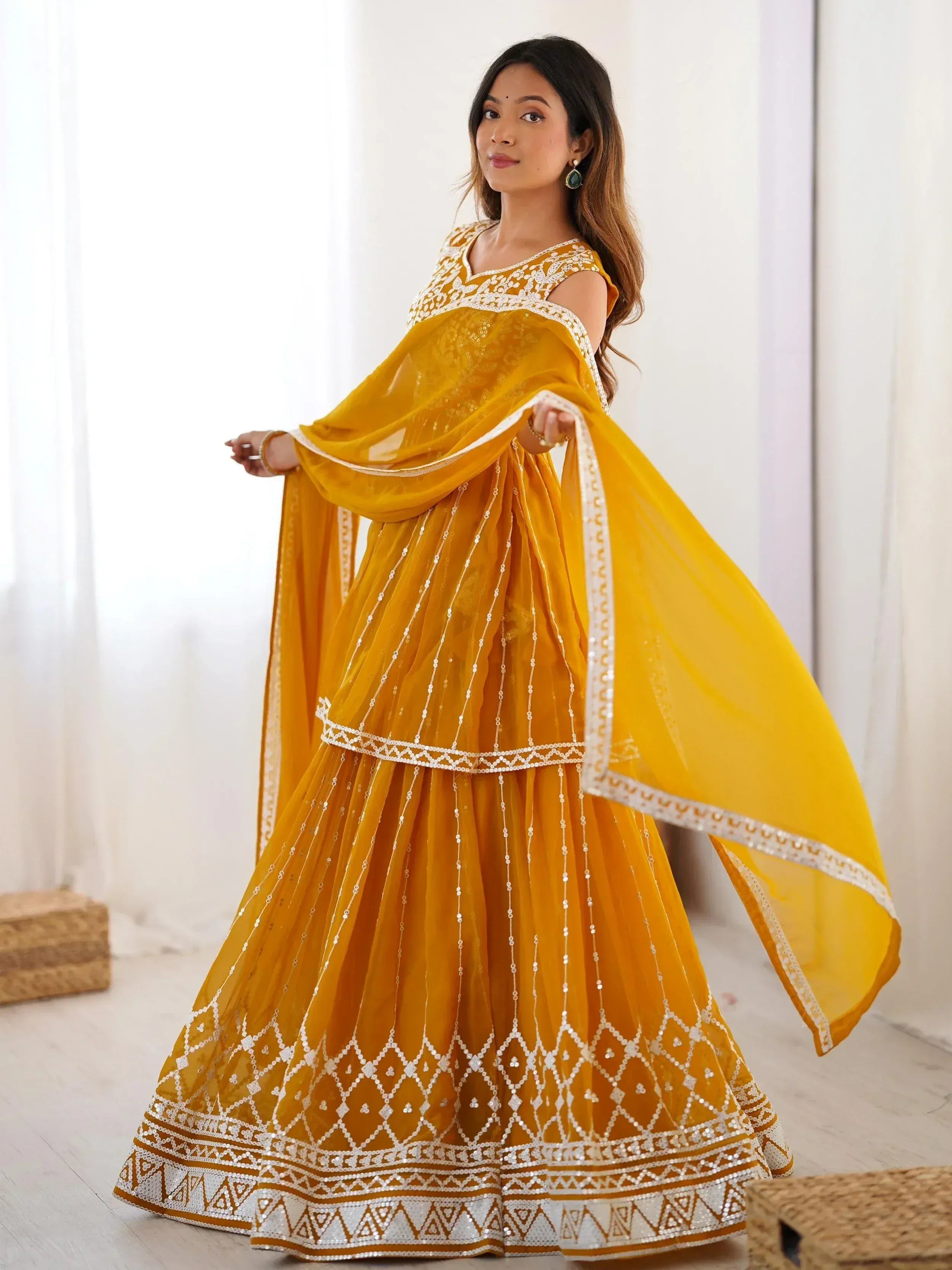 Yellow ethnic lehenga choli with white embroidery and sequins, perfect for Indian weddings and festivals