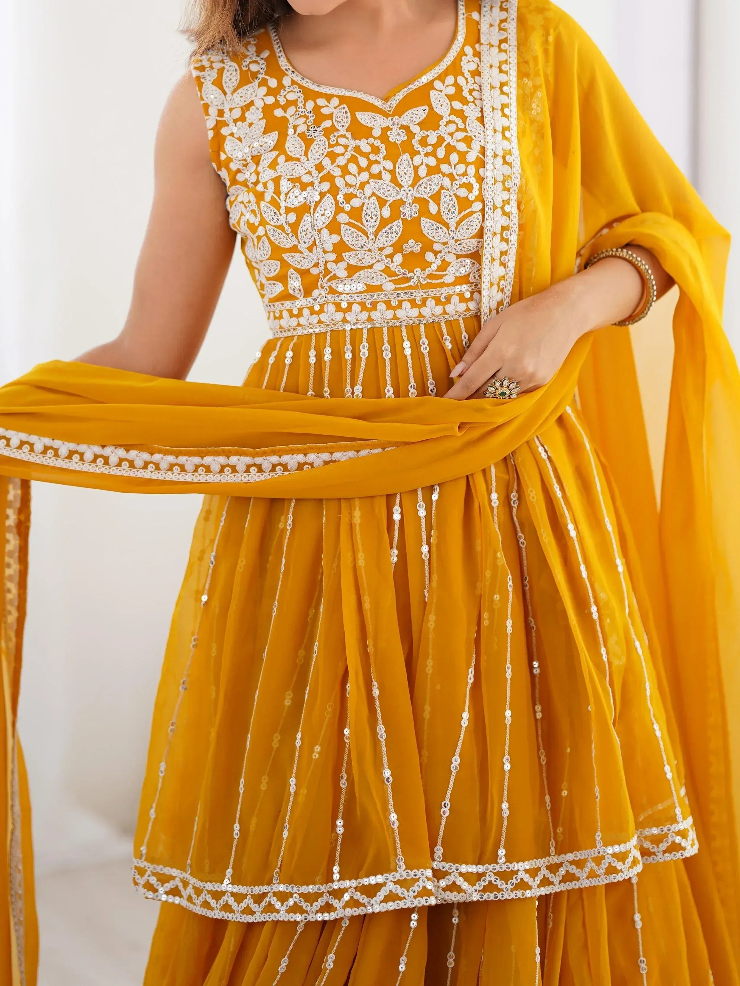 Yellow ethnic anarkali with white floral embroidery and sequin detailing, perfect for Indian occasions