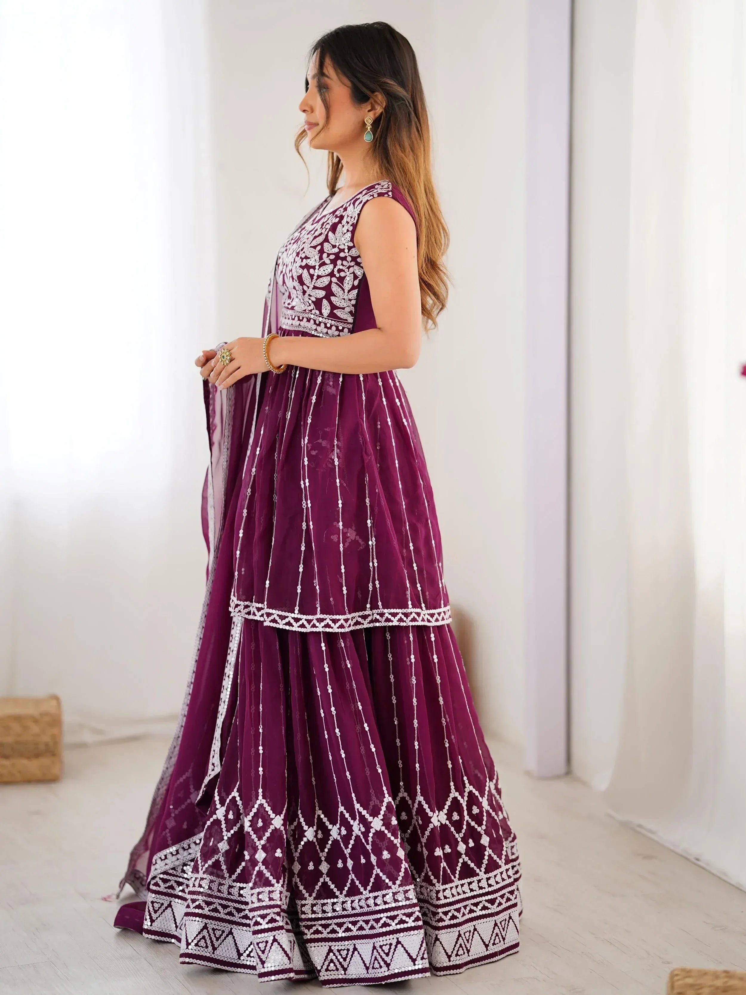 Elegant purple Indian ethnic gown with white embroidery and sequin detailing, perfect for festive occasions.