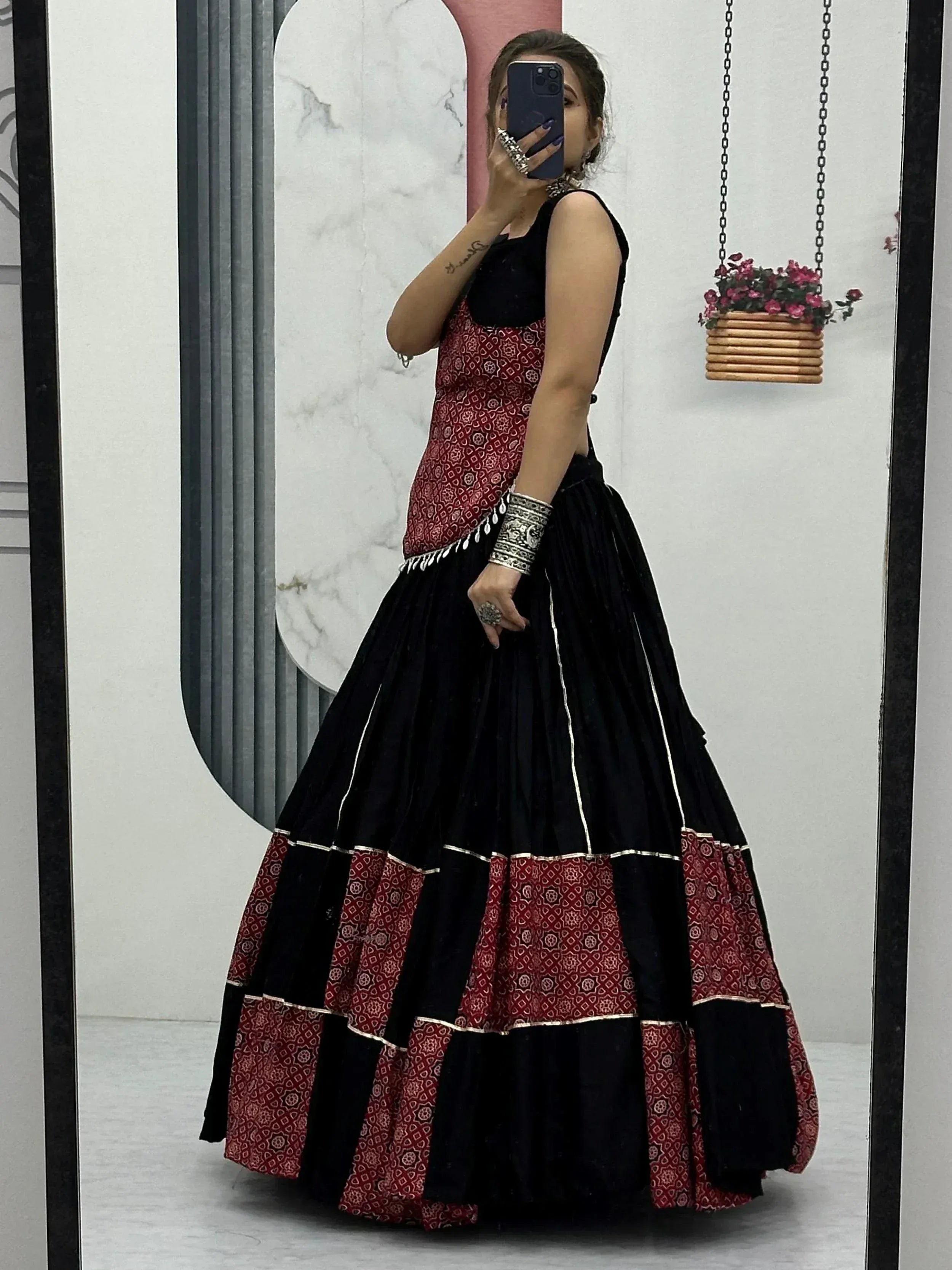 Black and red ethnic lehenga choli with printed patterns, perfect for Indian weddings or festive occasions.