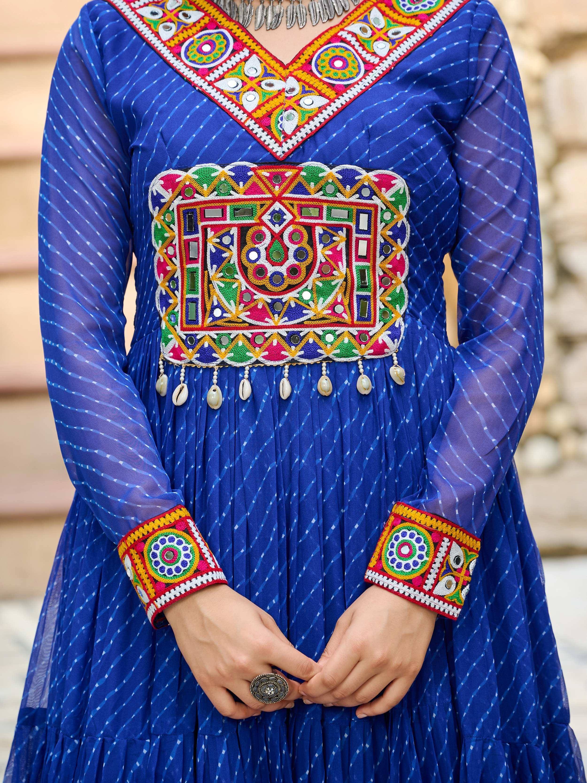 Blue ethnic gown with mirror work, embroidery, and shell tassels, perfect for Indian festive wear.