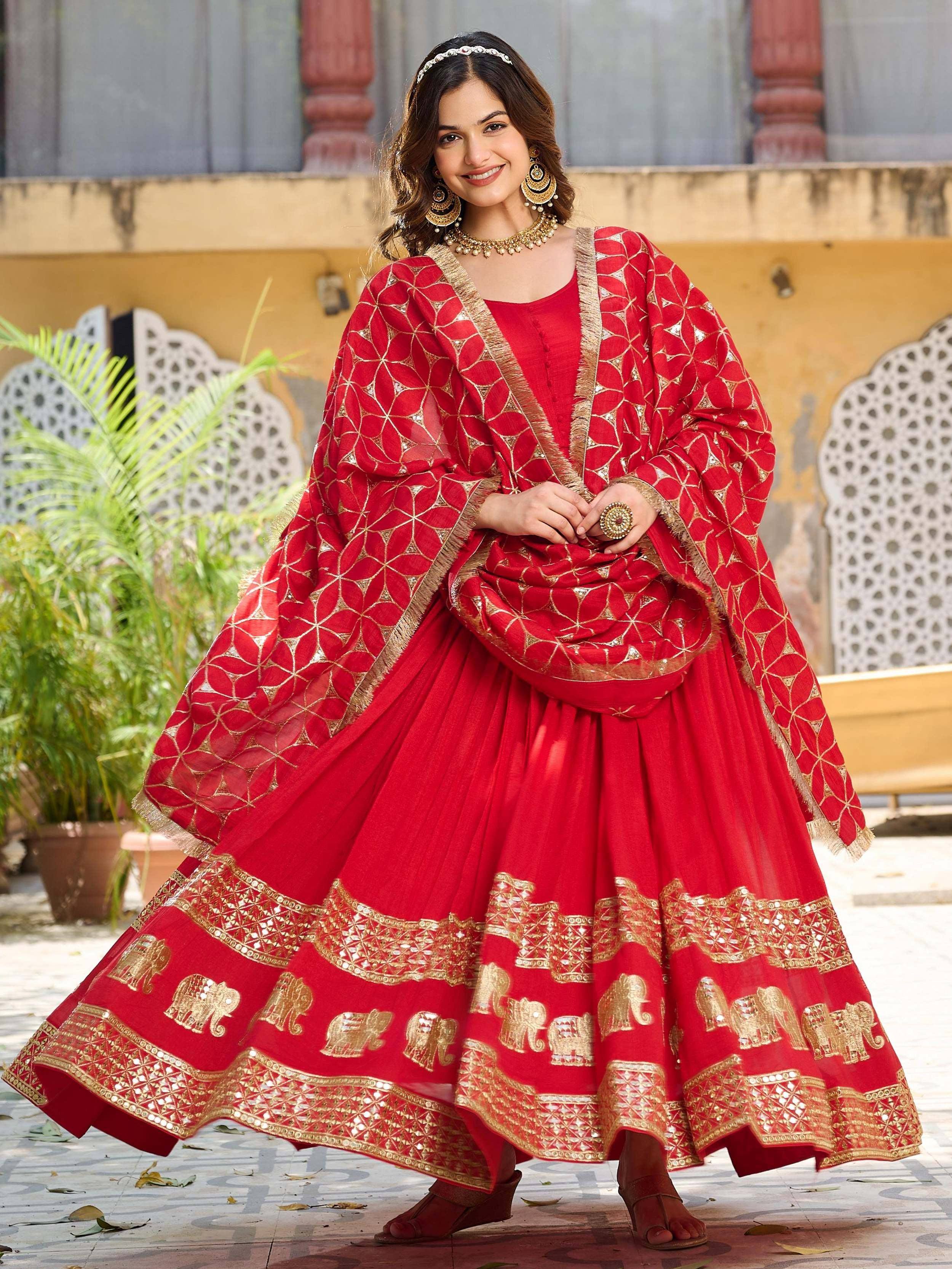 Red ethnic lehenga choli with gold elephant print and mirror work, perfect for Indian weddings and festivals
