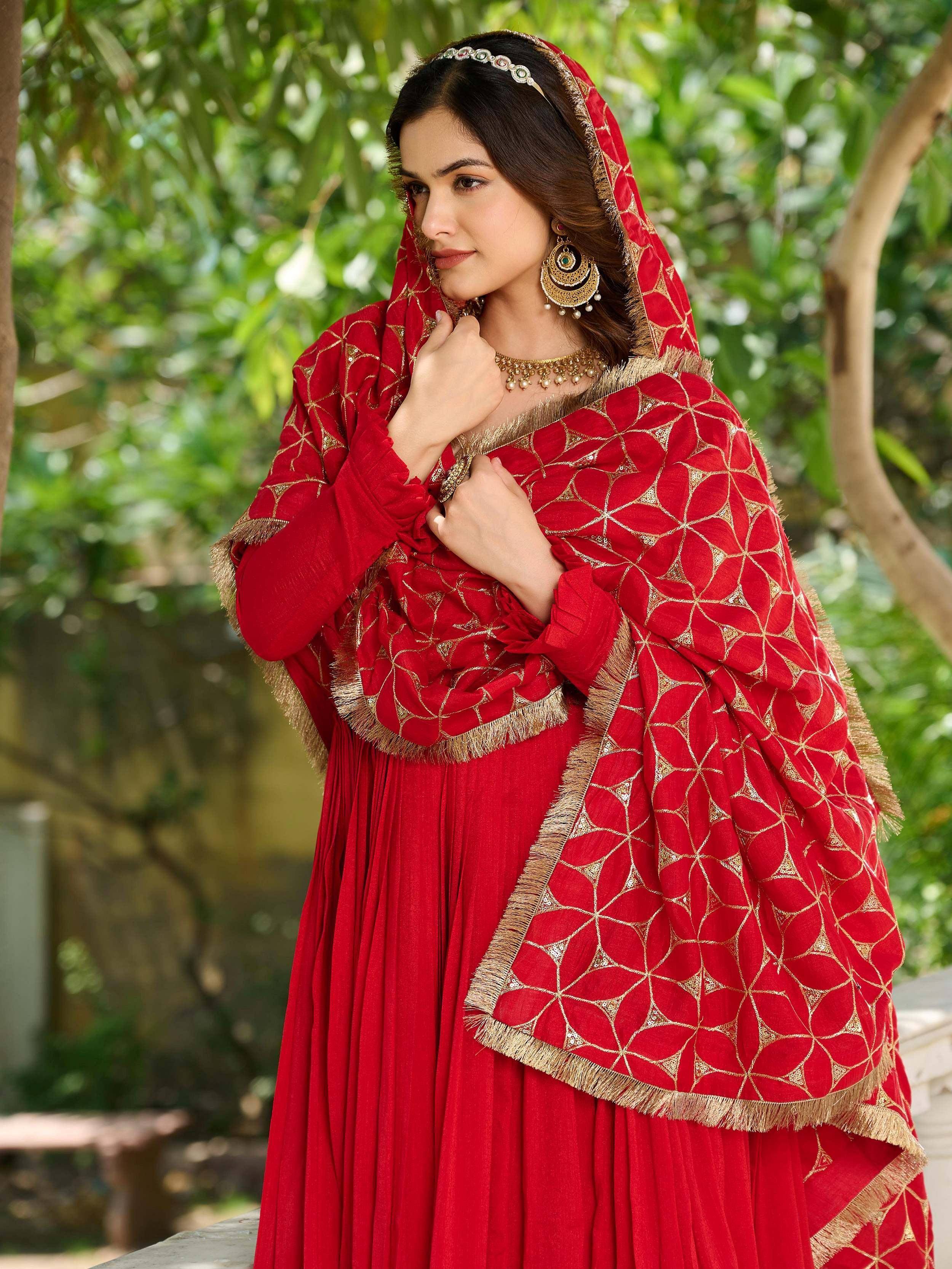 Red ethnic anarkali with gold embroidery and dupatta, perfect for Indian weddings and festive occasions.