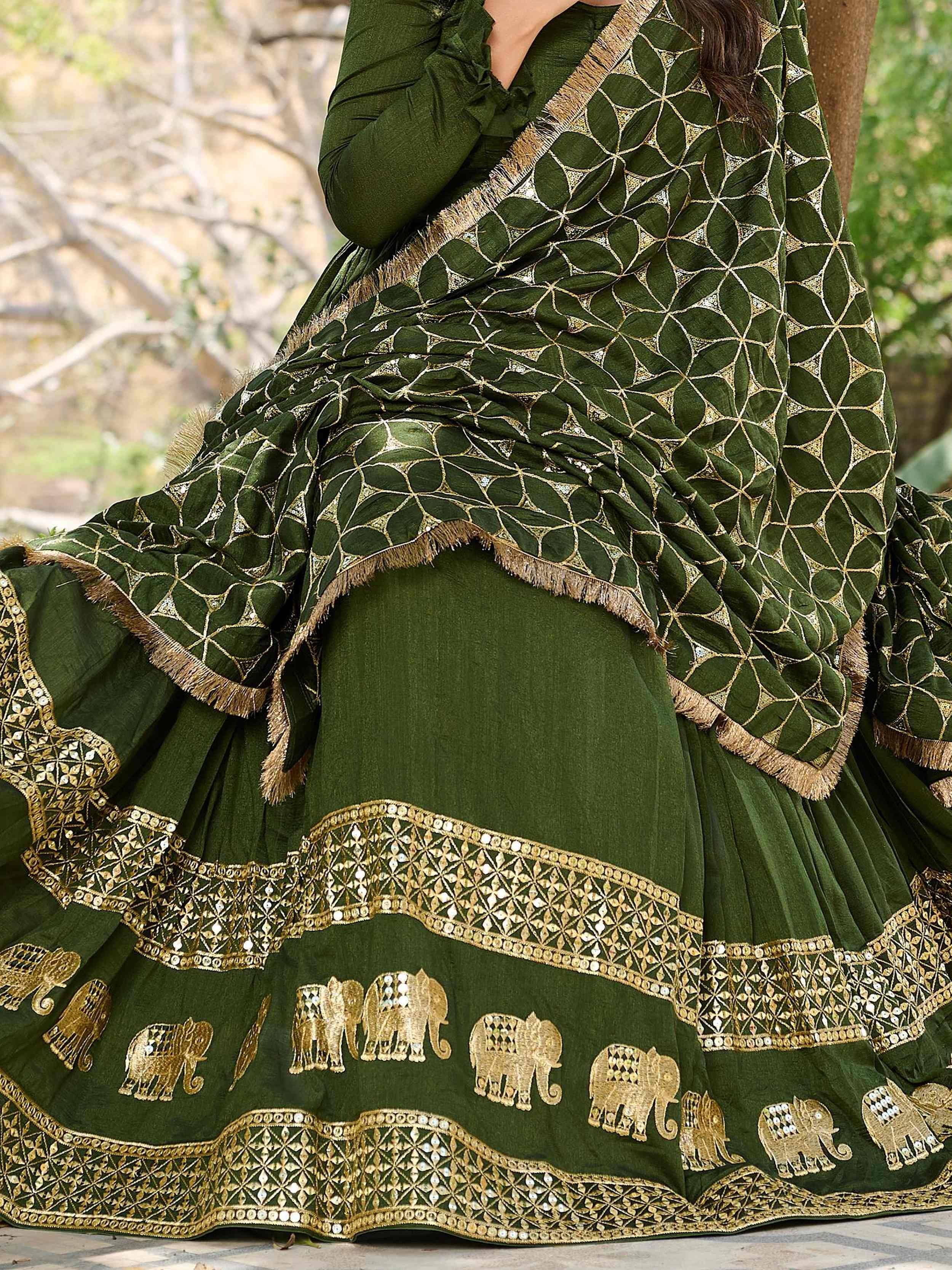 Green ethnic lehenga with gold elephant embroidery and geometric patterns, perfect for festive occasions.