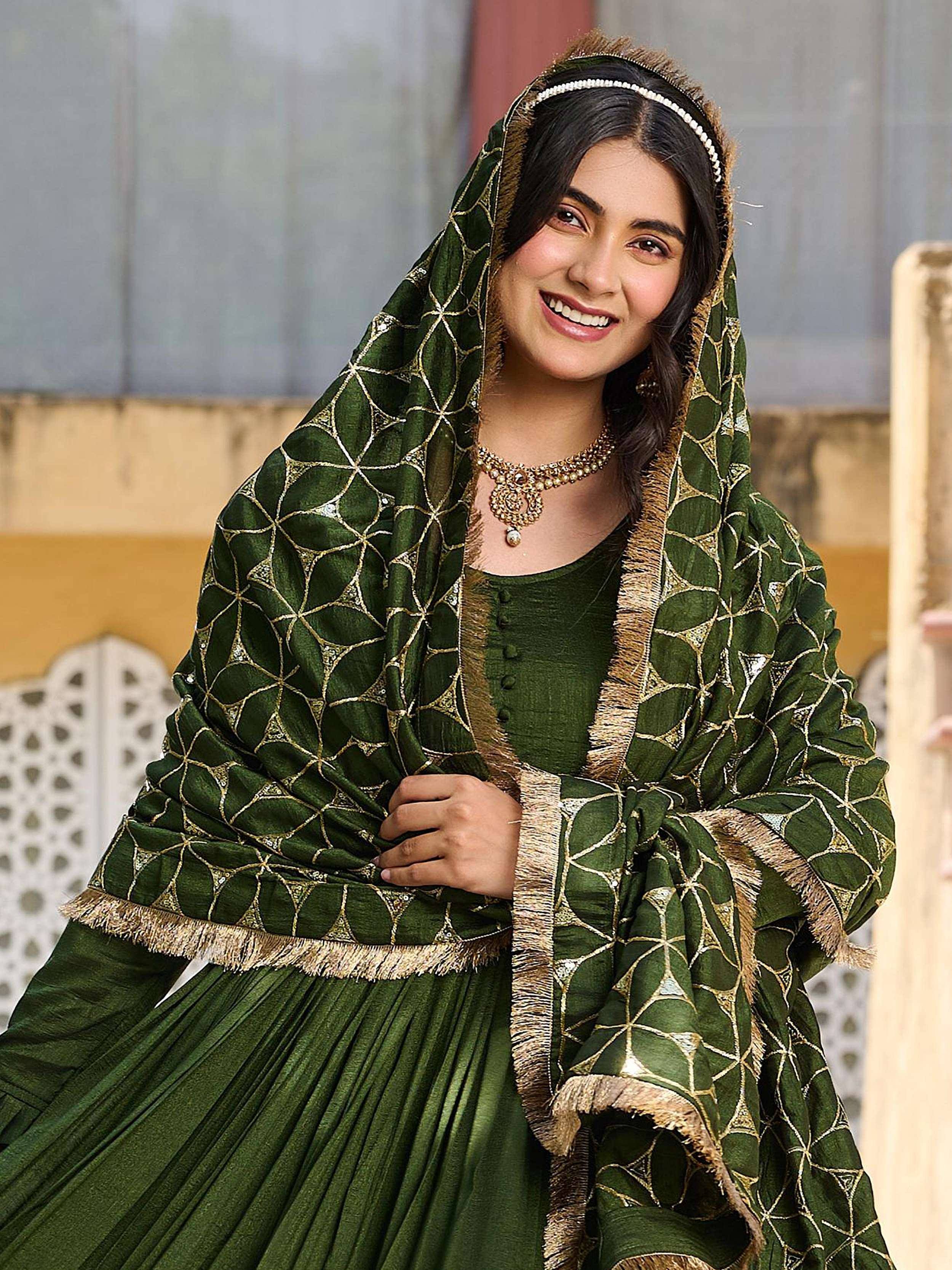 Green ethnic lehenga choli with gold embroidery and dupatta, perfect for Indian weddings and festive occasions.