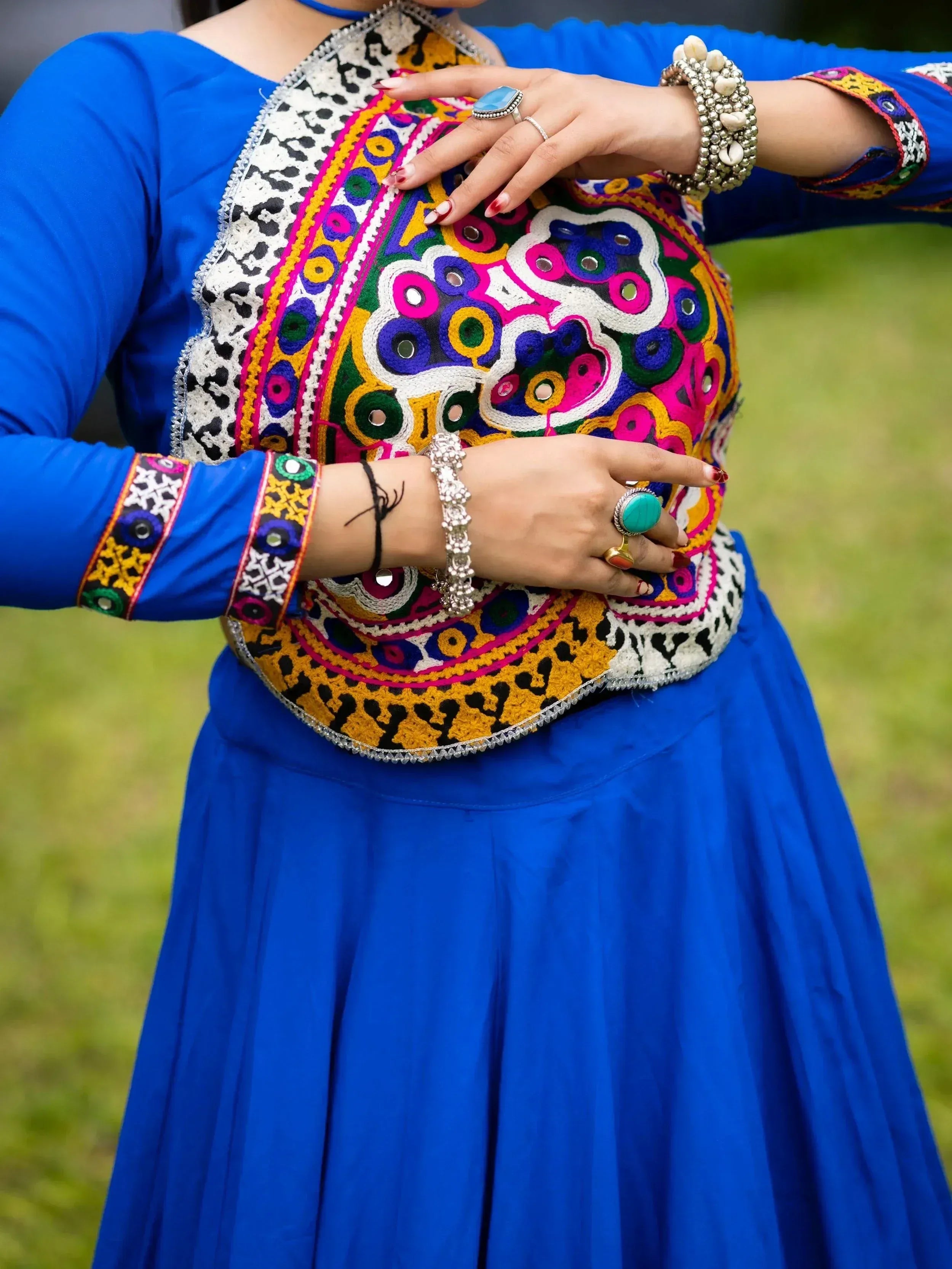 Vibrant blue ethnic gown with colorful mirror work and embroidery, perfect for Indian festive occasions.