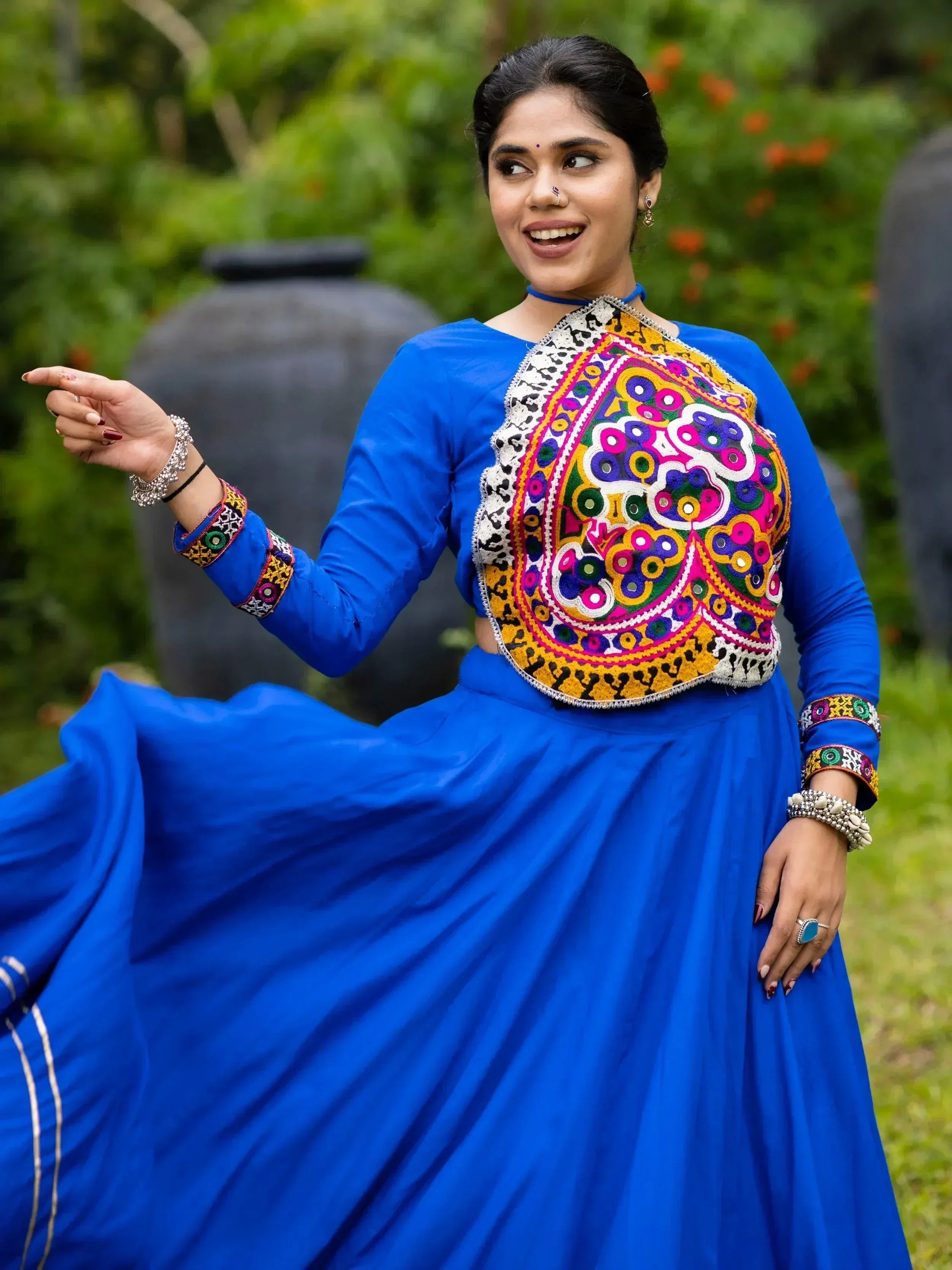 Vibrant blue ethnic lehenga choli with colorful mirror work, perfect for festive occasions and celebrations.